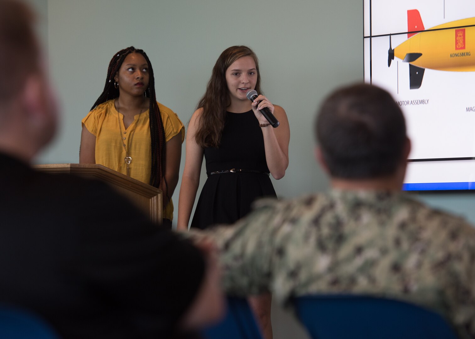 Mikyah Thompson (left), Rutherford High School junior and Anna Rudek (right) Bay High School senior, present their final Science and Engineering Apprenticeship Program presentations to mark the completion of their eight-week summer internship program at Naval Surface Warfare Center Panama City Division July 26.