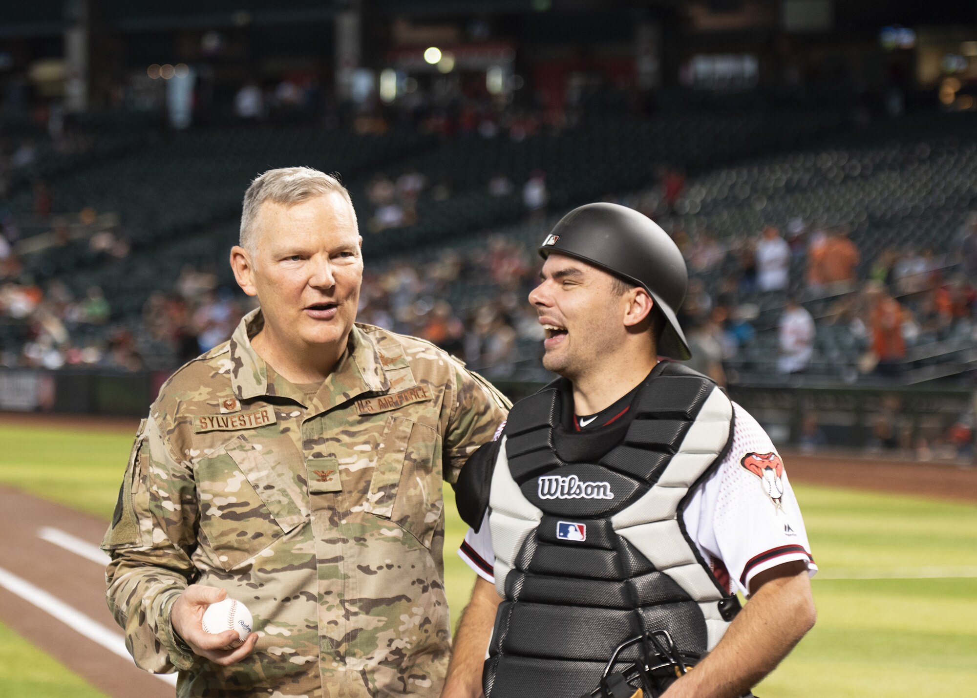 Col. Robert Sylvester, 56th Mission Support Group commander, embraces his son, Robert Sylvester Jr., July 24, 2019, at Chase Field in Phoenix.