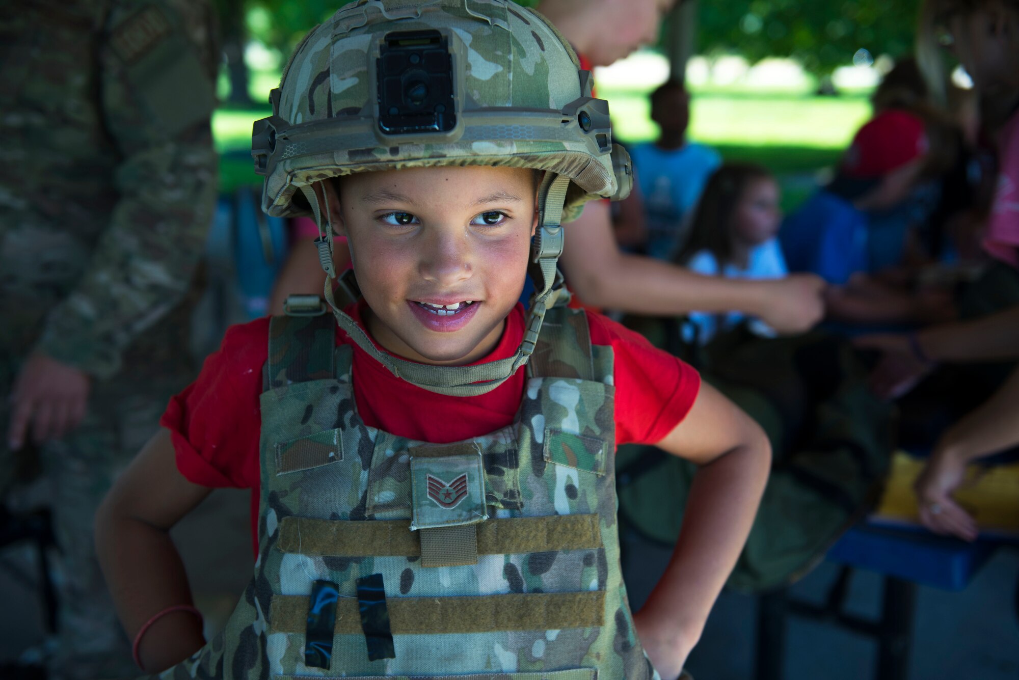 A child from Fairchild’s Youth Center tries on protective gear from the 92nd Civil Engineer Squadron Explosive Ordnance Disposal flight during the Summer Youth Fair at Fairchild Air Force, Washington, July 25, 2019. Approximately 100 children from across Fairchild participated in the fair. (U.S. Air Force photo by Airman 1st Class Lawrence Sena)