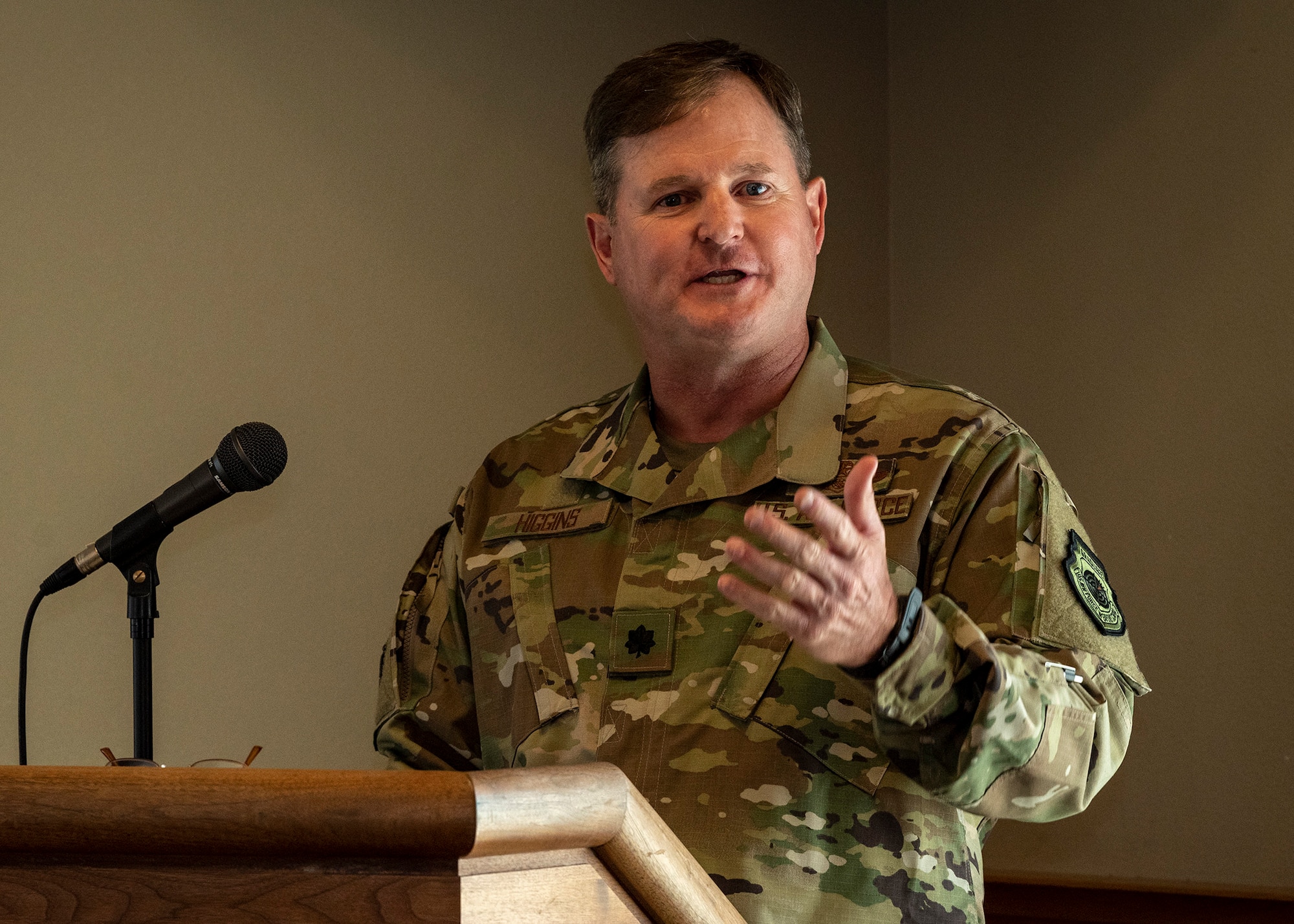 An Airman speaks to a crowd.