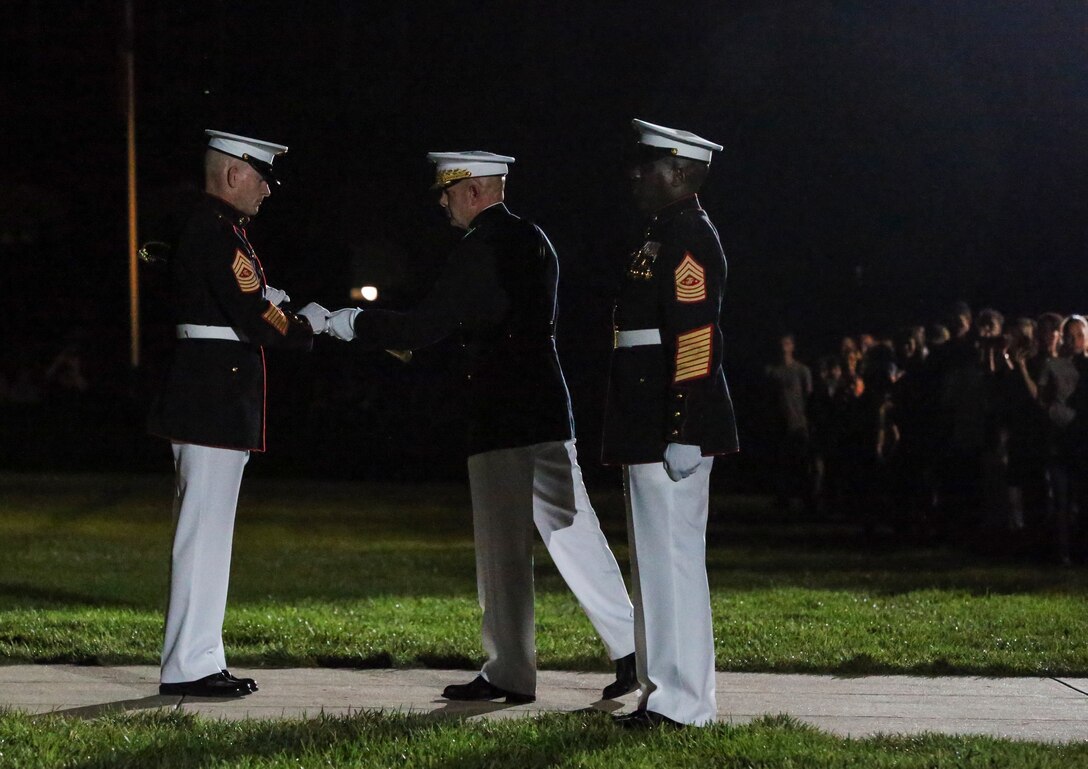 Sergeant Maj. Troy E. Black, 19th Sergeant Major of the Marine Corps, accepts the sword of office from Commandant of the Marine Corps Gen. David H. Berger during a relief and appointment ceremony at Marine Barracks Washington, D.C., July 26, 2019. The emblematic passing of the sword of office signifies the transfer of the senior enlisted leader of Marines and advisor to the commandant from 18th Sergeant Major of the Marine Corps Sgt. Maj. Ronald L. Green to Sgt. Maj. Black.