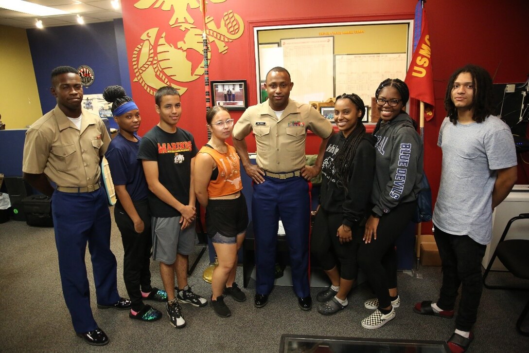 Staff Sgt. Damali Alliman poses with his group of future Marines at Recruiting Substation Bridgeport, Bridgeport, Connecticut, July 18, 2019. Alliman recently won the “Centurion” for recruiting 100 individuals into the Marine Corps during his 36 month tour on recruiting duty.