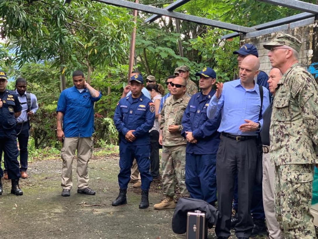 A group of military officials talk.