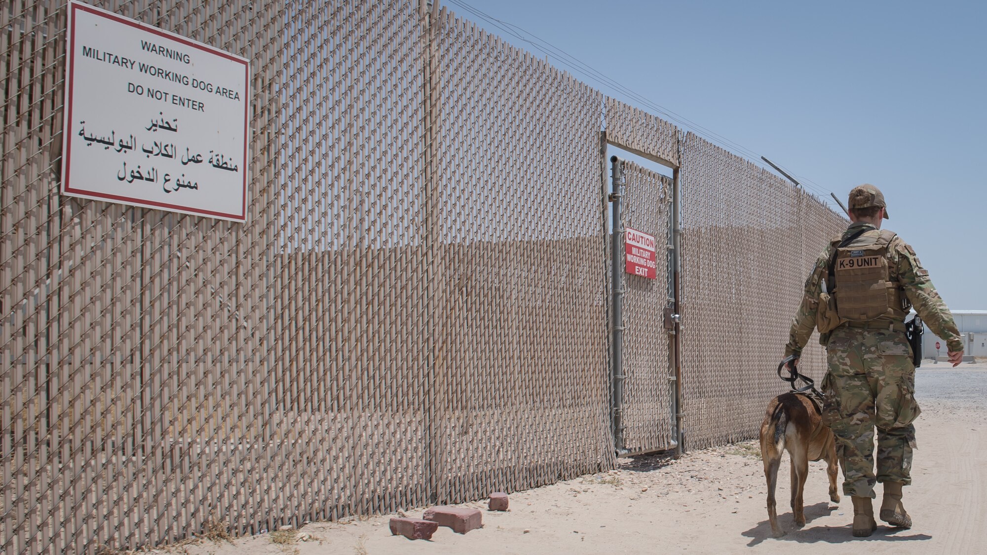 U.S. Air Force Staff Sgt. Kathyrn Malone, 386th Expeditionary Security Forces Squadron military working dog handler, walks her MWD, Uurska, outside the MWD compound at Ali Al Salem Air Base, Kuwait, July 24, 2019. Malone and Uurska are both deployed from the 55th Security Forces Squadron, Offutt Air Force Base, Neb. (U.S. Air Force photo by Tech. Sgt. Daniel Martinez)