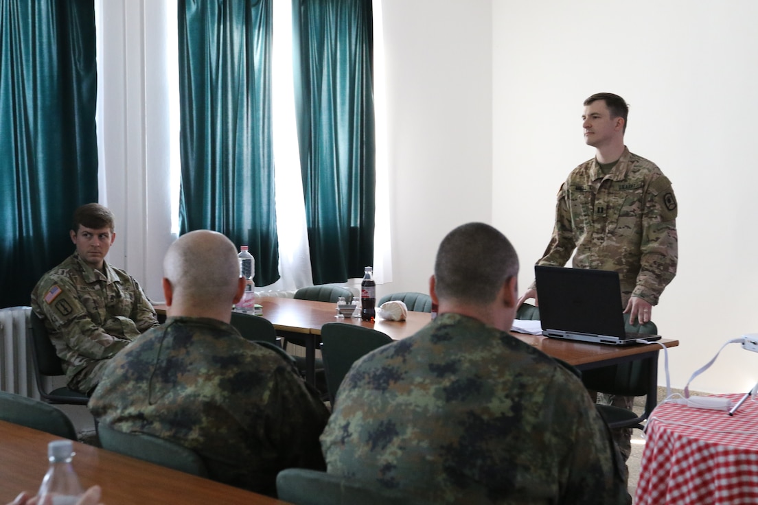 U.S. Army Reserve Cpt. Douglas Magill, 221st Public Affairs Detachment Commander, 361st Civil Affairs Brigade, Kaiserslautern, Germany, instructs U.S. and NATO Soldiers on engagement techniques at the Multinational Civil-Military Co-operation (CIMIC) Center (MNCC), Ócsa, Hungary, June 11. The MNCC tracks CIMIC and Civil Affairs elements operating in support of NATO and U.S. Army Europe exercises including Immediate Response, Saber Guardian and Swift Response. These exercises utilize a common collective defense scenario focused on furthering partner capacity and improving interoperability.

 (U.S. Army Reserve photo by Sgt. Christopher Stelter, 221st Public Affairs Detachment)