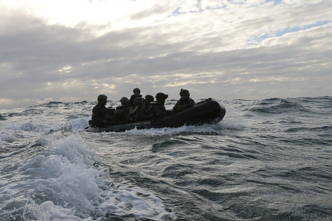 Marines with Battalion Landing Team, 2nd Battalion, 1st Marines, 31st Marine Expeditionary Unit, ride ashore in a Combat Rubber Raiding Craft during a boat raid exercise in the Coral Sea, July 3, 2019. The Marines launched from the amphibious dock landing ship USS Ashland (LSD 48), part of the Wasp Amphibious Ready Group, with embarked 31st MEU, while operating in the Indo-Pacific region to enhance interoperability with partners and serve as a ready-response force for any type of contingency, while simultaneously providing a flexible and lethal crisis response force ready to perform a wide range of military operations. (Official U.S. Marine Corps photo by Cpl. Brennan Priest)