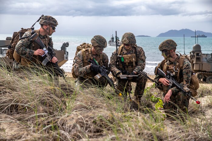 U.S. Marines assess a terrain map during a simulated amphibious assault of exercise Talisman Sabre 19 in Bowen, Australia, July 22, 2019. Talisman Sabre provides an opportunity to conduct operations in a combined, joint and interagency environment that will increase participating countries' abilities to plan and execute contingency responses, from combat missions to humanitarian assistance efforts. (U.S. Marine Corps photo by Lance Cpl. Tanner D. Lambert)