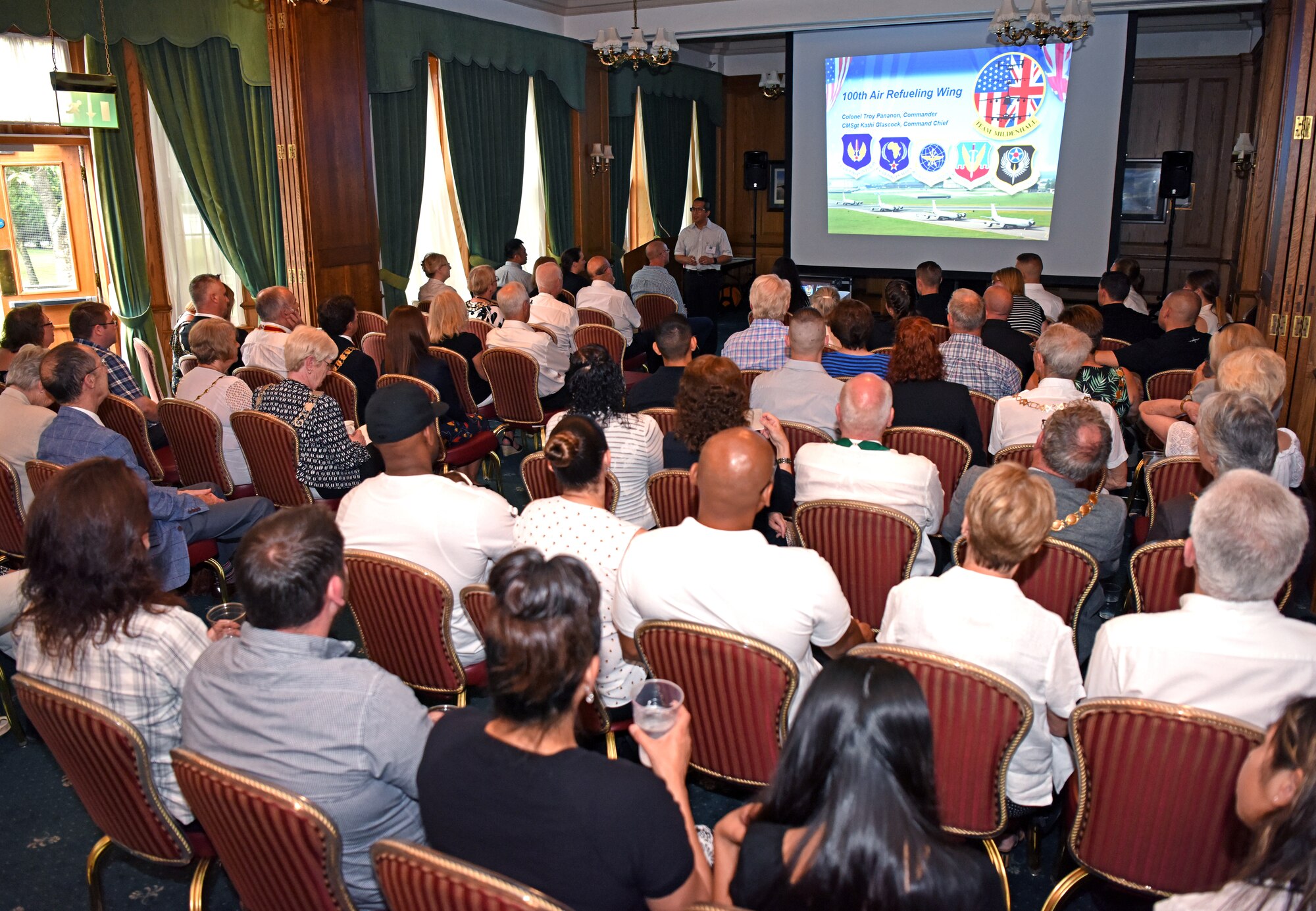 Colonel Troy Pananon, 100th Air Refueling Wing commander, speaks during a briefing on the history of RAF Mildenhall during the New Mayors’ Barbecue at RAF Mildenhall, England, July 27, 2019. Pananon covered a number of topics, ranging from the economic effect Airmen have on the community to the history of the base. The event provided a casual setting where local community leaders could build partnerships with base leadership. (U.S. Air Force photo by Airman 1st Class Brandon Esau)