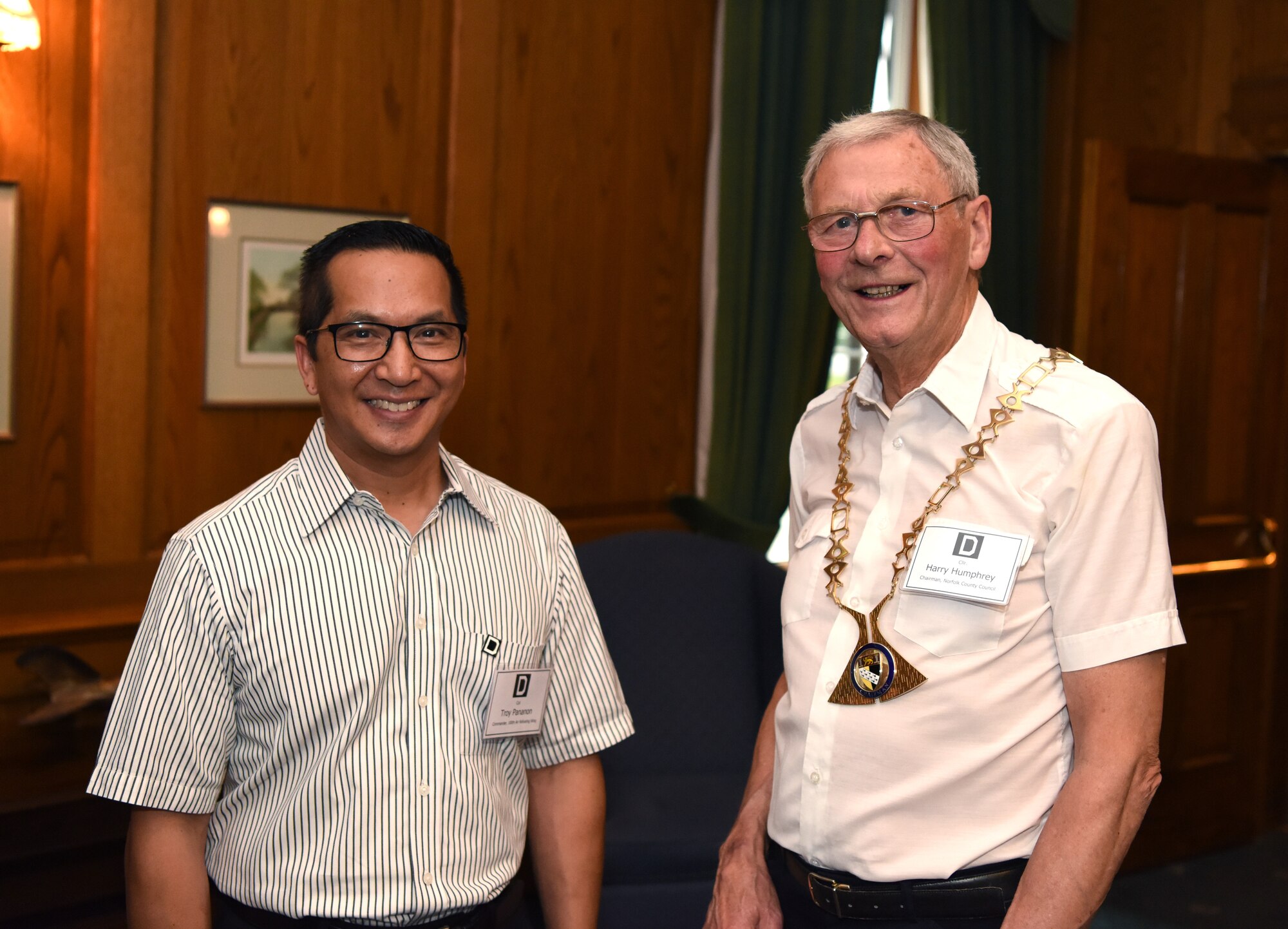 U.S. Air Force Col. Troy Pananon, 100th Air Refueling Wing commander, and Councillor Harry Humphrey, Norfolk County Council chairman, pose for a photo during the New Mayors’ Barbecue at RAF Mildenhall, England, July 27, 2019. During the event, Pananon covered a number of topics, ranging from the economic effect Airmen have on the community to the history of the base. The event provided a casual setting where local community leaders could build partnerships with base leadership. (U.S. Air Force photo by Airman 1st Class Brandon Esau)