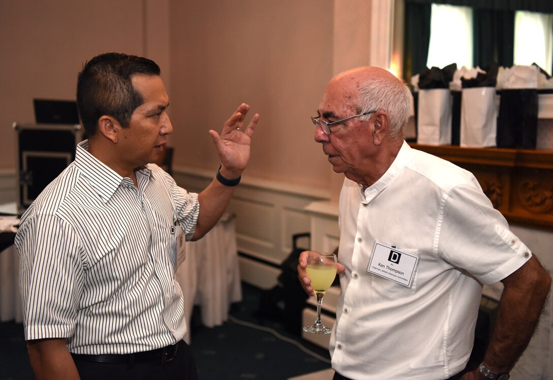Colonel Troy Pananon, 100th Air Refueling Wing commander, speaks with Ken Thompson, British American Committee chairman, during the New Mayors’ Barbecue at RAF Mildenhall, England, July 27, 2019. The annual event consisted of wing mission and economic impact briefs, a KC-135 Stratotanker nose art-themed lunch and friendly games of cornhole. (U.S. Air Force photo by Airman 1st Class Brandon Esau)
