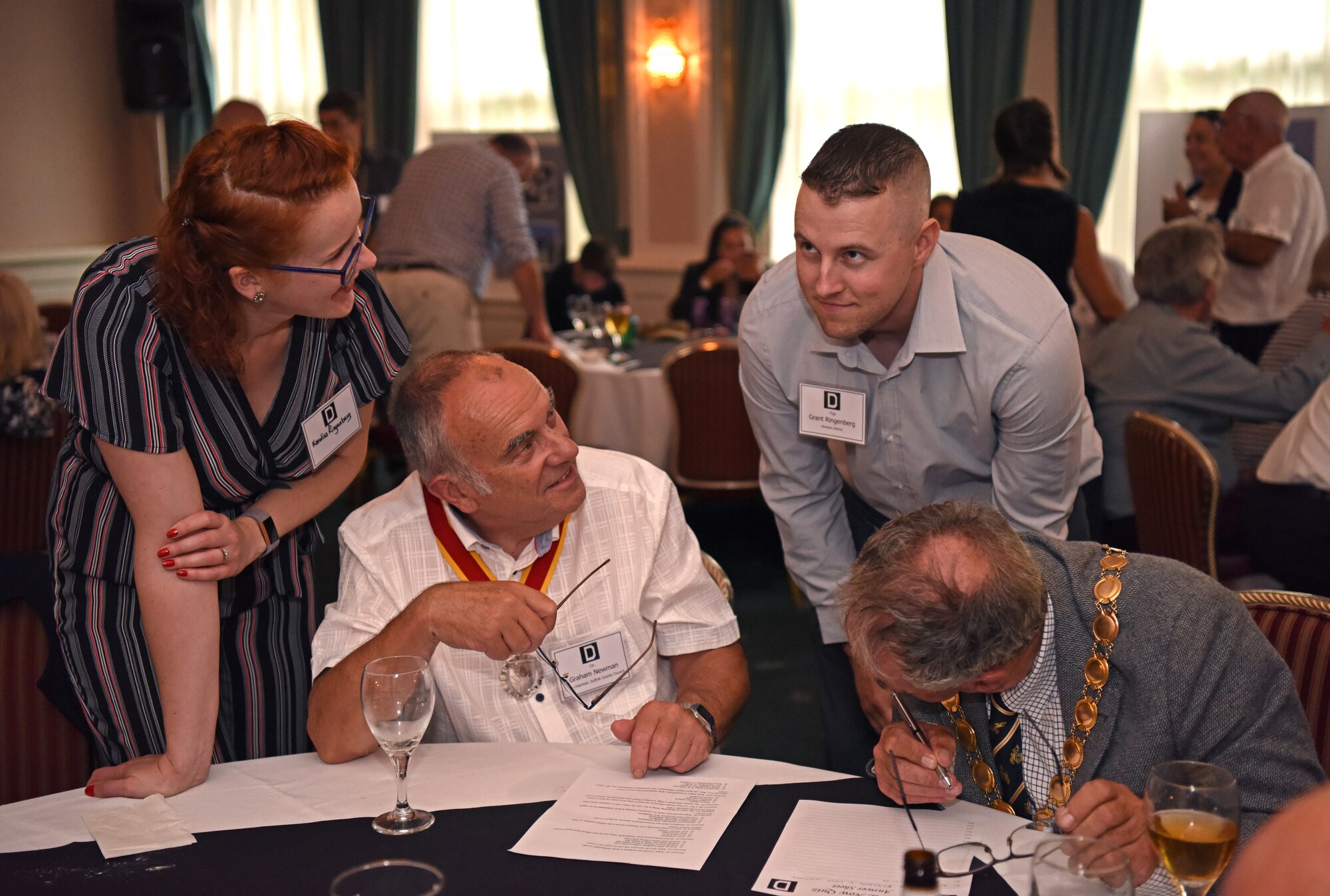 Local British community leaders discuss trivia questions with RAF Mildenhall personnel during the New Mayors’ Barbecue at RAF Mildenhall, England, July 27, 2019. The event informed local community leaders about the base and gave them a chance to get to know the base leadership on a personal level and strengthen partnership. (U.S. Air Force photo by Airman 1st Class Brandon Esau)
