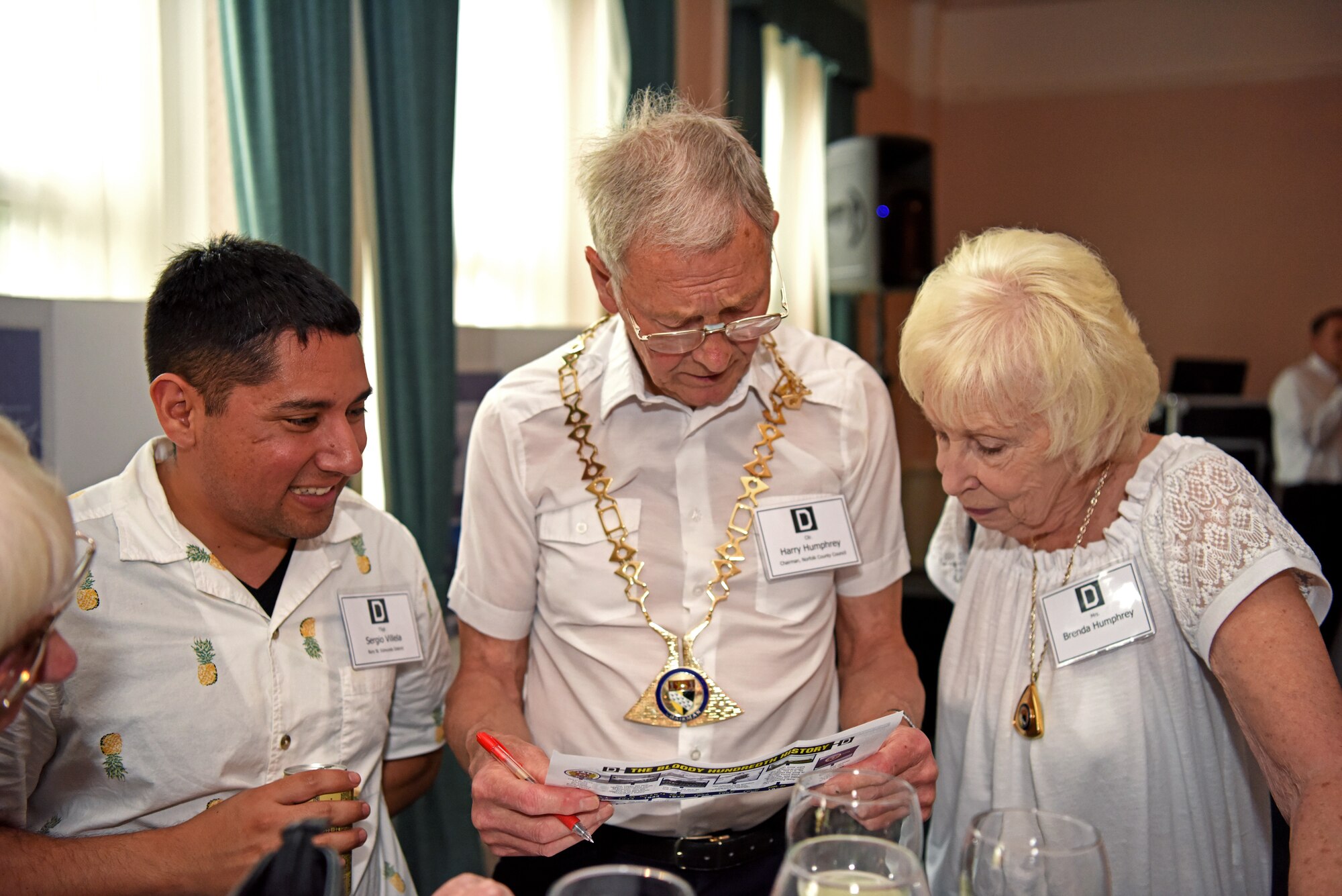 U.S. Air Force Tech. Sgt. Sergio Villela, 100th Civil Engineer Squadron firefighter, left, Councillor Harry Humphrey, Norfolk County Council chairman, and his wife Brenda, play trivia during the New Mayors’ Barbecue at RAF Mildenhall, England, July 27, 2019. The annual event hosted by the U.S. Air Force Col. Troy Pananon, 100th Air Refueling Wing commander, consisted of wing mission and economic impact briefs, a KC-135 Stratotanker nose art-themed lunch and friendly games of cornhole. (U.S. Air Force photo by Airman 1st Class Brandon Esau)