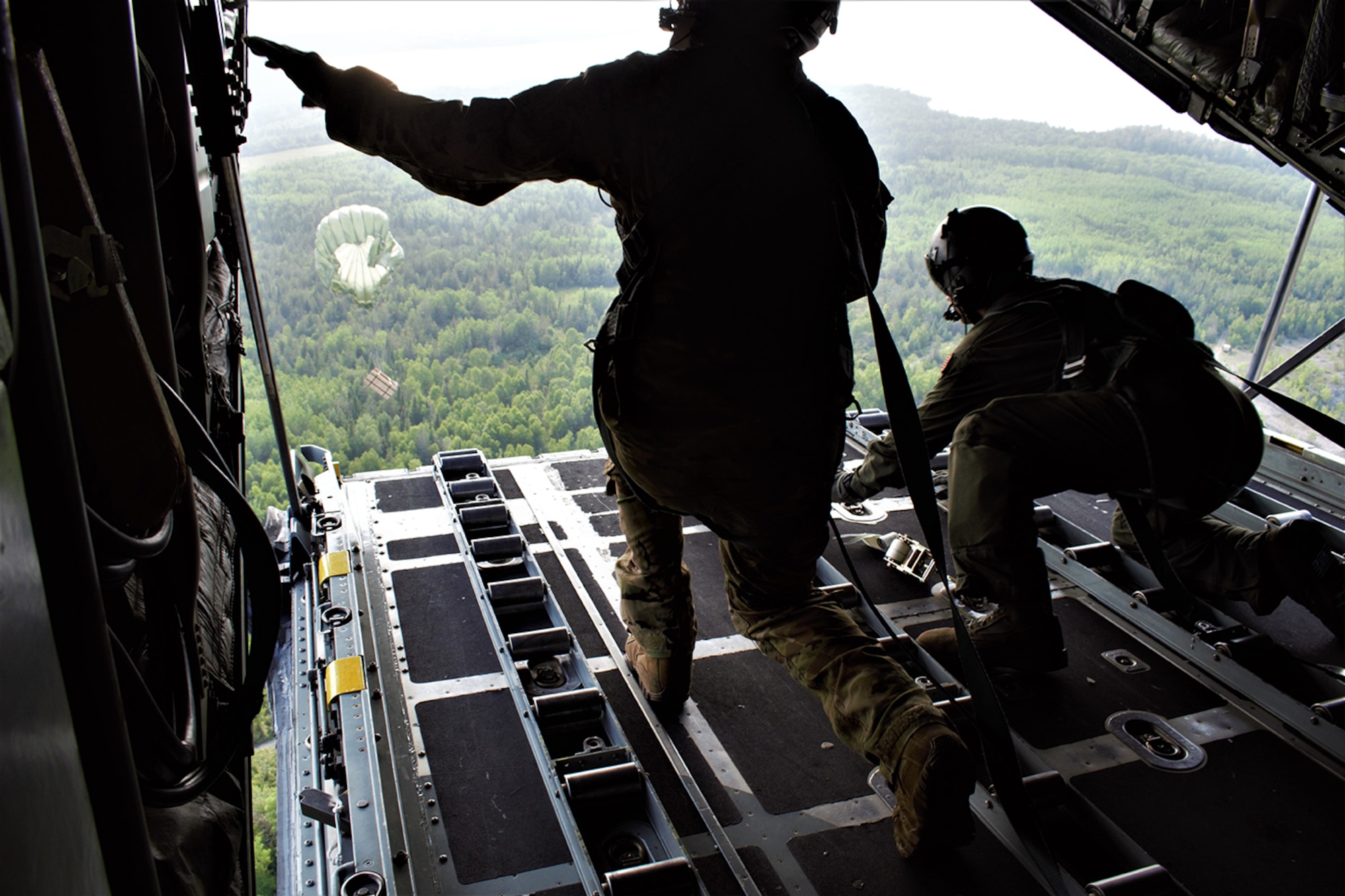 A C-130H Hercules crew assigned to the 182d Airlift Wing, Peoria Air National Guard Base, Illinois, flies over Rogers City, Michigan, July 25, 2019, on an integrated air drop training mission during exercise Northern Strike 19.