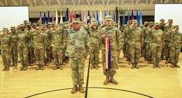 Col. Anthony Dekeyzer, director, 14th Human Resources Sustainment Center (HRSC), 1st Theater Sustainment Command (TSC), salutes at the front of the formation during a deployment ceremony at the Sadowski Center at Fort Knox, Ky., July 26, 2019.
