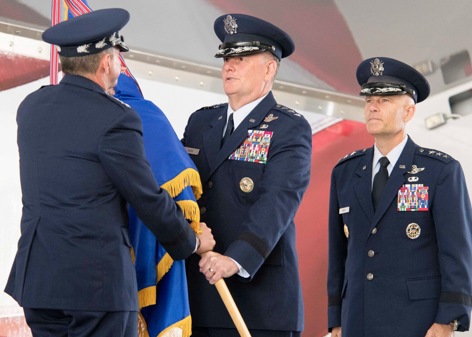 U.S. Air Force Chief of Staff Gen. David L. Goldfein (left) presents the Air Education and Training Command guidon to Lt. Gen. Brad Webb, new commander of AETC, during a change of command ceremony at Joint Base San Antonio-Randolph July 26. At right is U. S. Air Force Lt. Gen. Steve Kwast, outgoing AETC commander. Webb, a 1984 graduate of the U.S. Air Force Academy, is a command pilot with more than 3,700 flying hours, including 117 combat hours in Afghanistan, Iraq and Bosnia.