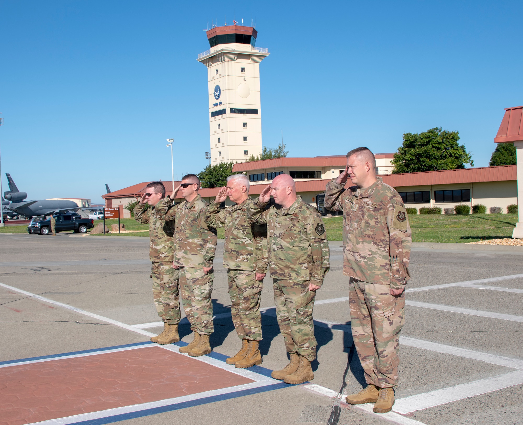 Senior leadership with Travis Air Force Base, California, render a salute as U.S. Army Gen. Steve Lyons, U.S. Transportation Command commander, Scott Air Force Base, Illinois, July 24, 2019 arrives to base. Lyons interacted with Travis Airmen and toured several units while on the base visit. (U.S. Air Force photo by Heide Couch)