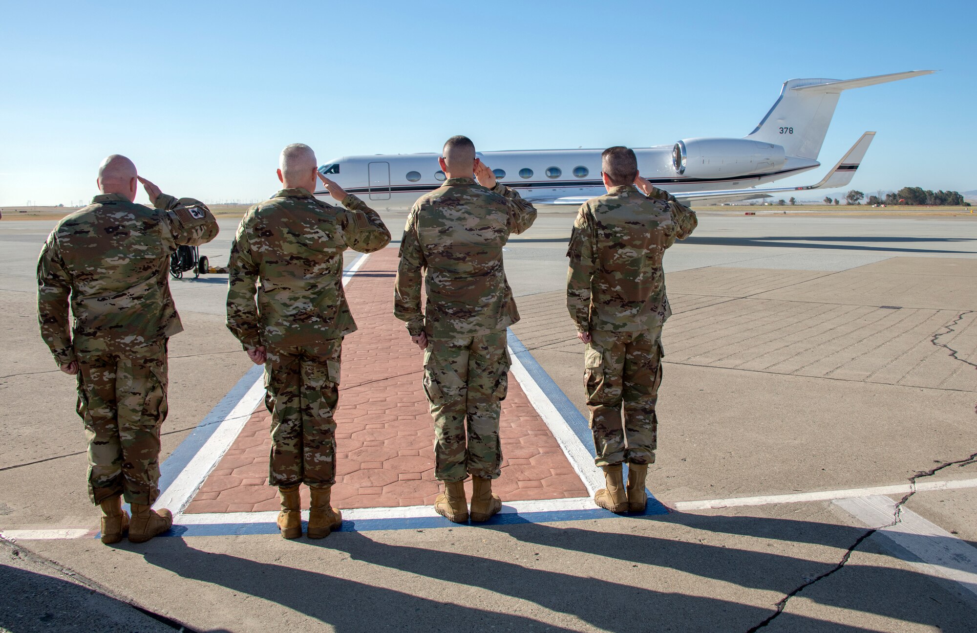 Senior leadership with Travis Air Force Base, California, render a salute as U.S. Army Gen. Steve Lyons, U.S. Transportation Command commander, Scott Air Force Base, Illinois, July 24, 2019 arrives to base. Lyons interacted with Travis Airmen and toured several units while on the base visit. (U.S. Air Force photo by Heide Couch)