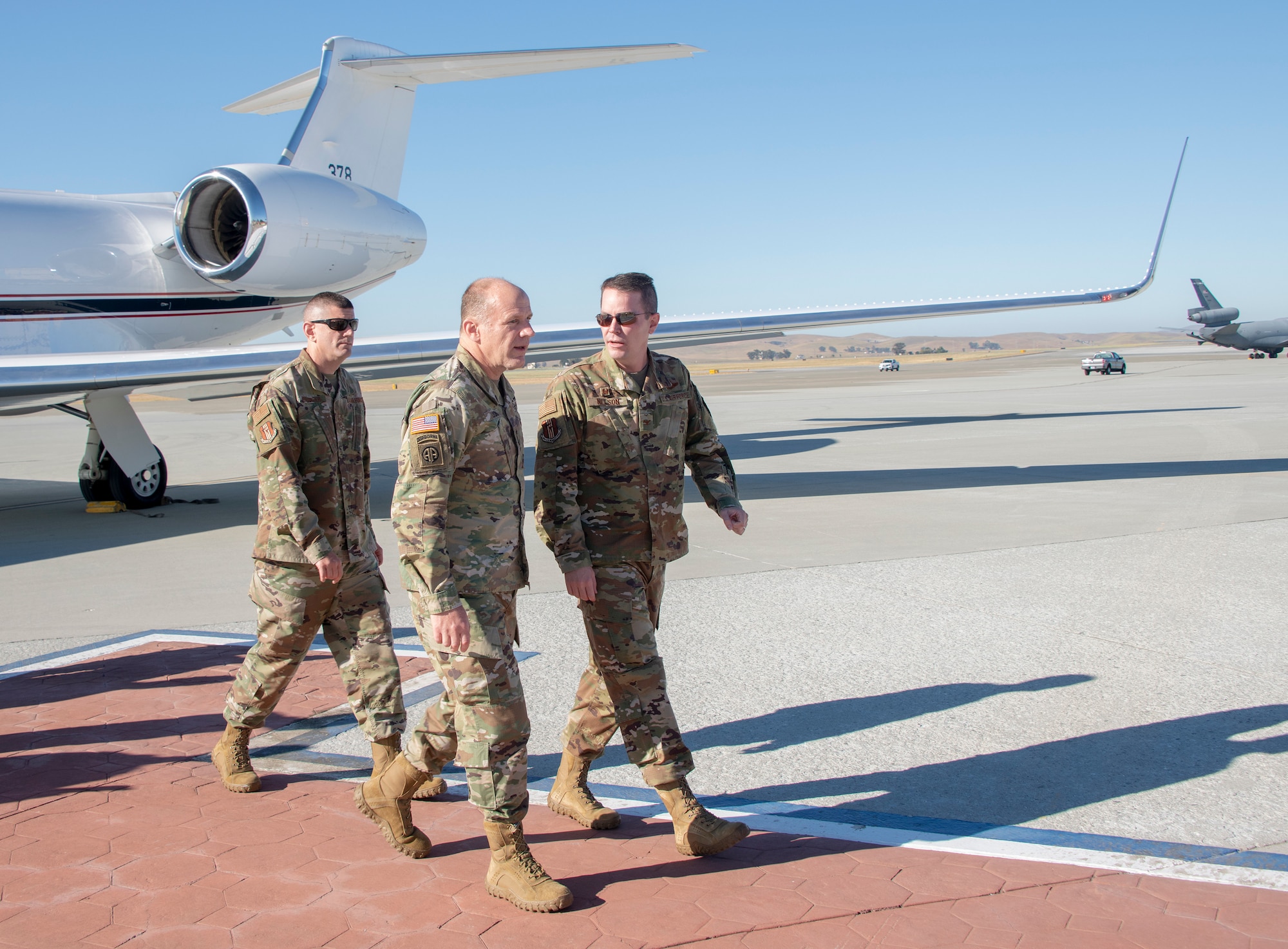 U.S. Army Gen. Steve Lyons, U.S. Transportation Command commander, Scott Air Force Base, Illinois, is escorted by Col. Jeffrey Nelson, 60th Air Mobility Wing commander, and Chief Master Sgt. Derek Crowder, 60th AMW command chief, July 24, 2019, at Travis Air Force Base, California. Lyons interacted with Travis Airmen and toured several units while on the base visit. (U.S. Air Force photo by Heide Couch)