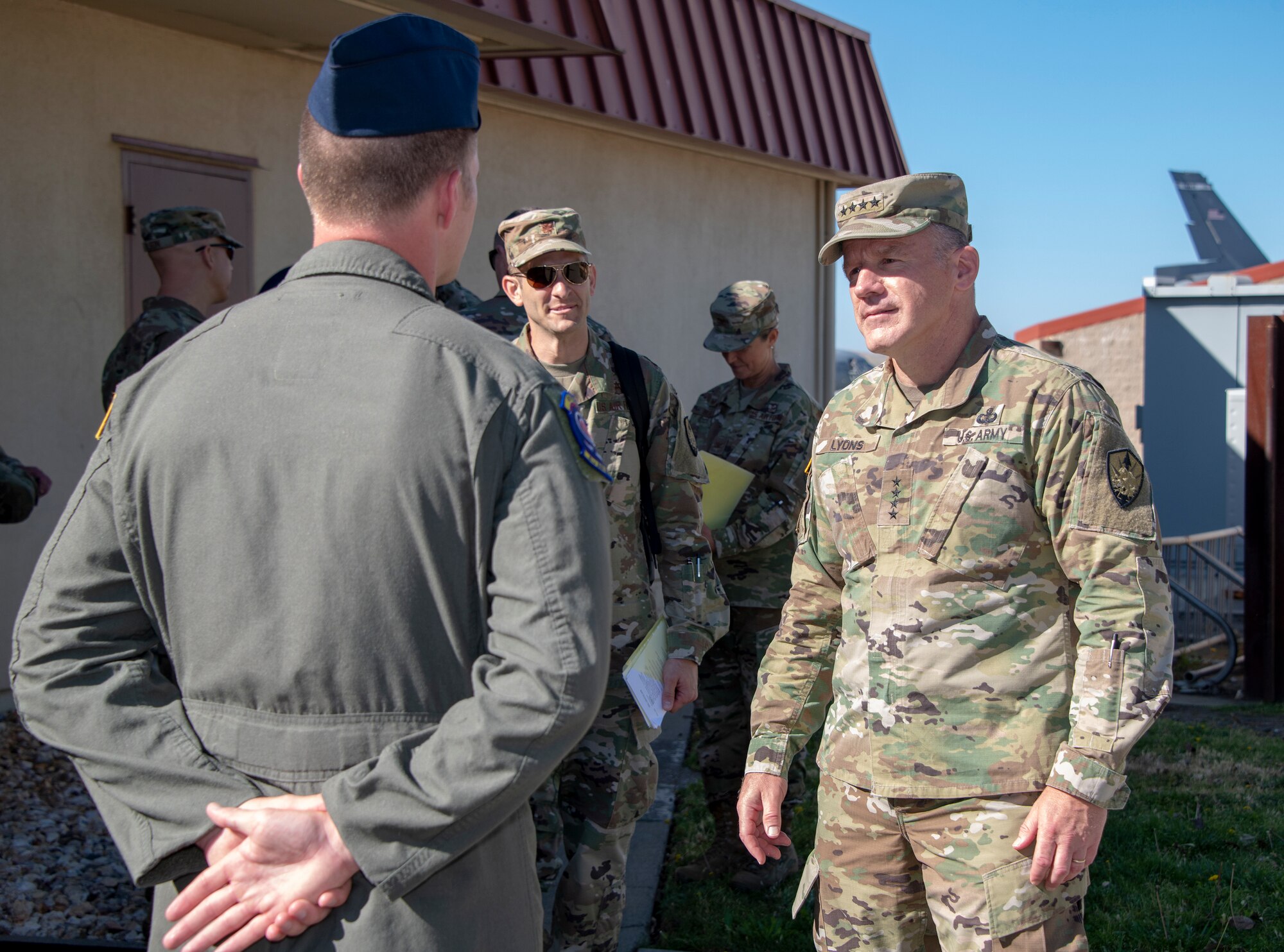 U.S. Army Gen. Steve Lyons, right, U.S. Transportation Command commander, Scott Air Force Base, Illinois, listens to Airman 1st Class Taran Lewis, 9th Air Refueling Squadron in-flight refueling specialist, July 24, 2019 at Travis Air Force Base, California. Lyons had the opportunity to interact with Travis Airmen and tour several units while on the base visit. (U.S. Air Force photo by Heide Couch)
