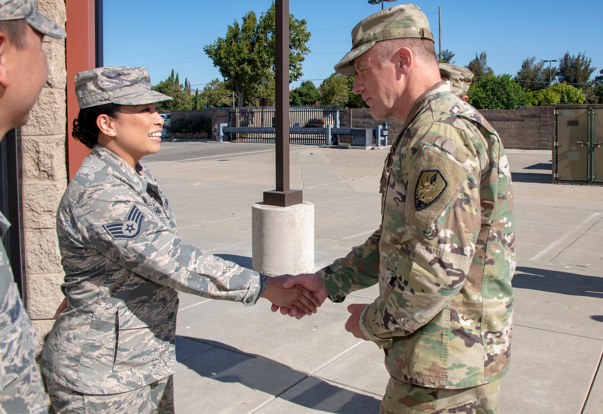 U.S. Army Gen. Steve Lyons, right, U.S. Transportation Command commander, Scott Air Force Base, Illinois, recognizes Staff Sgt. Cherielyn Amaba, 60th Diagnostics and Therapeutics Squadron noncommissioned officer in charge of mammography, as a star performer, July 24, 2019 at Travis Air Force Base, California. Lyons had the opportunity to interact with Travis Airmen and tour several units while on the base visit. (U.S. Air Force photo by Heide Couch)