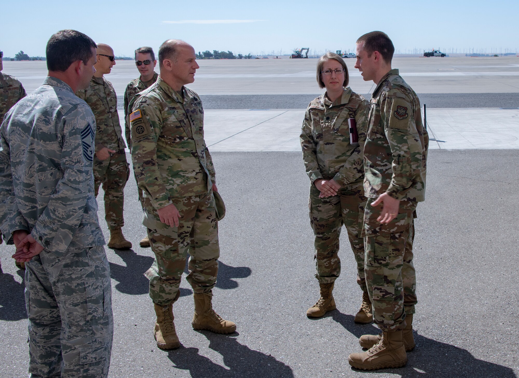 U.S. Army Gen. Steve Lyons, center, U.S. Transportation Command commander, Scott Air Force Base, Illinois, listens to Lt. Col. Kelly Smith, 60th Aerial Port Squadron commander, and Capt. Joshua Cross, 60th APS operations officer, right, July 24, 2019 at Travis Air Force Base, California. Lyons had the opportunity to interact with Travis Airmen and tour several units while on the base visit. (U.S. Air Force photo by Heide Couch)