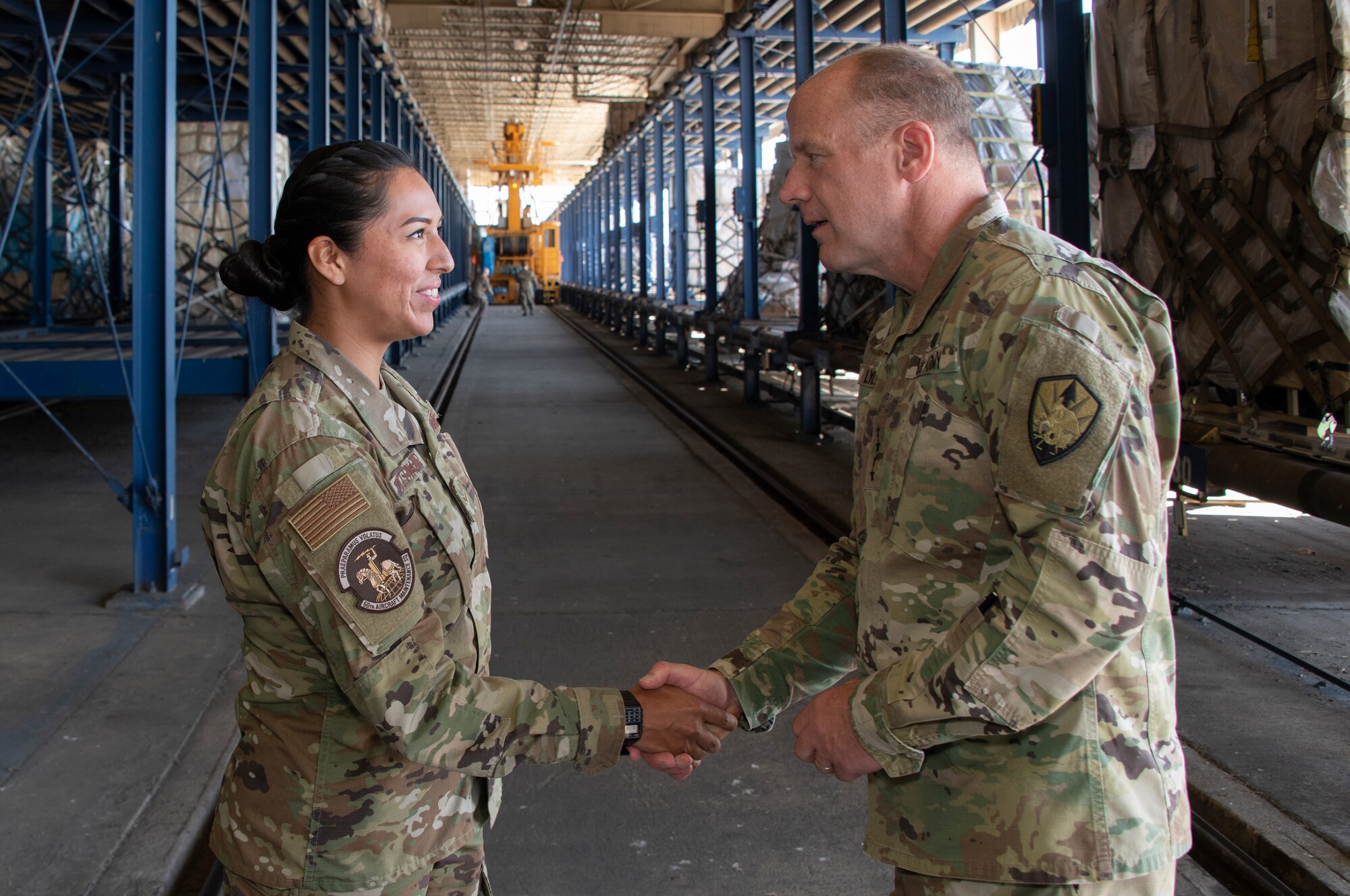 U.S. Army Gen. Steve Lyons, right, U.S. Transportation Command commander, Scott Air Force Base, Illinois, recognizes Airman 1st Class Shelby Yellowhair, 60th Aircraft Maintenance Squadron communication navigation systems apprentice, as a star performer, July 24, 2019 at Travis Air Force Base, California. Lyons had the opportunity to interact with Travis Airmen and tour several units while on the base visit. (U.S. Air Force photo by Heide Couch)