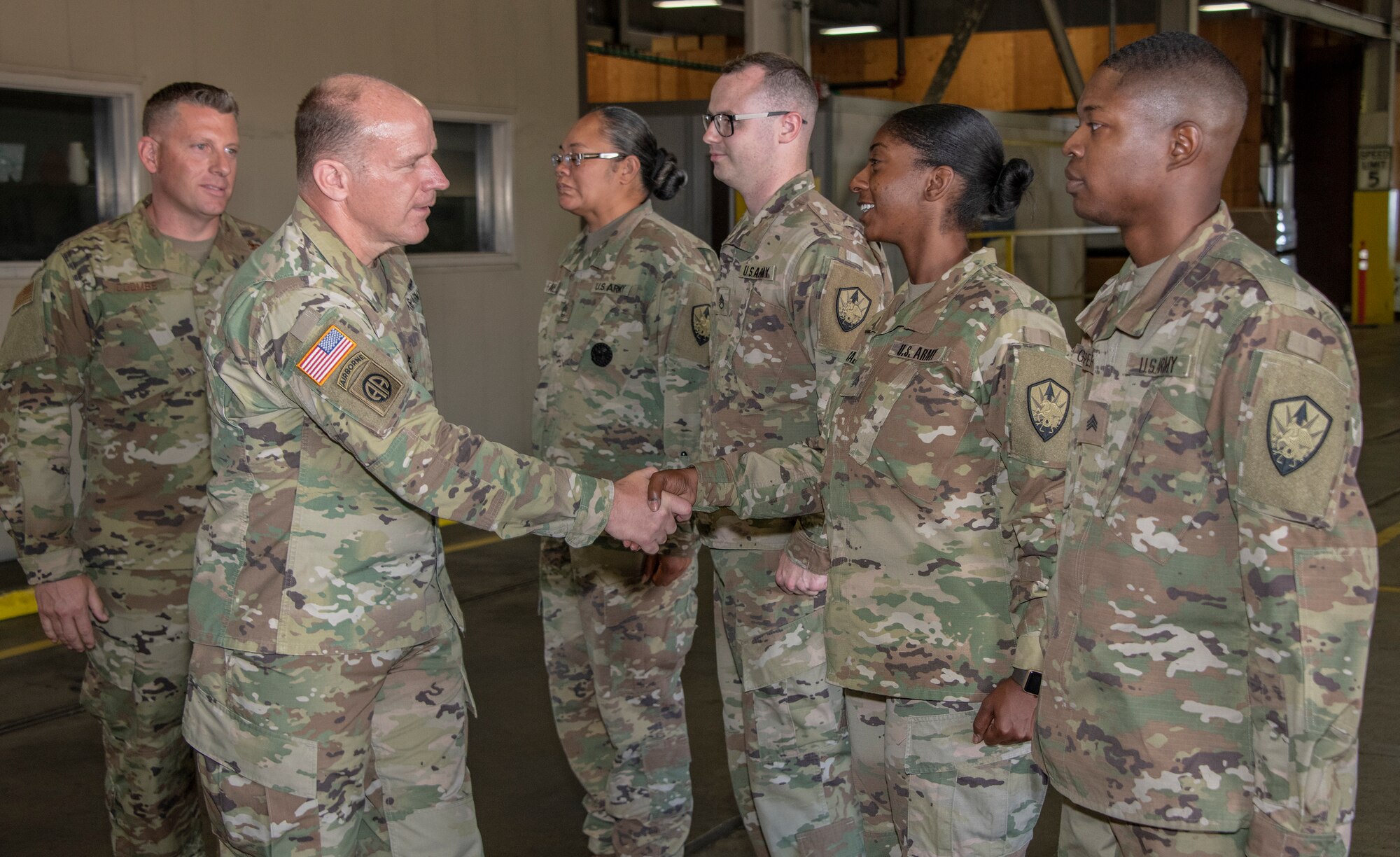 U.S. Army Gen.l Steve Lyons, U.S. Transportation Command commander, Scott Air Force Base, Illinois, greets members from the Defense Threat Reduction Agency during a visit to the 60th Aerial Port Squadron warehouse, July 24, 2019 at Travis Air Force Base, California. Lyons had the opportunity to interact with Travis Airmen and tour several units while on the base visit. (U.S. Air Force photo by Heide Couch)