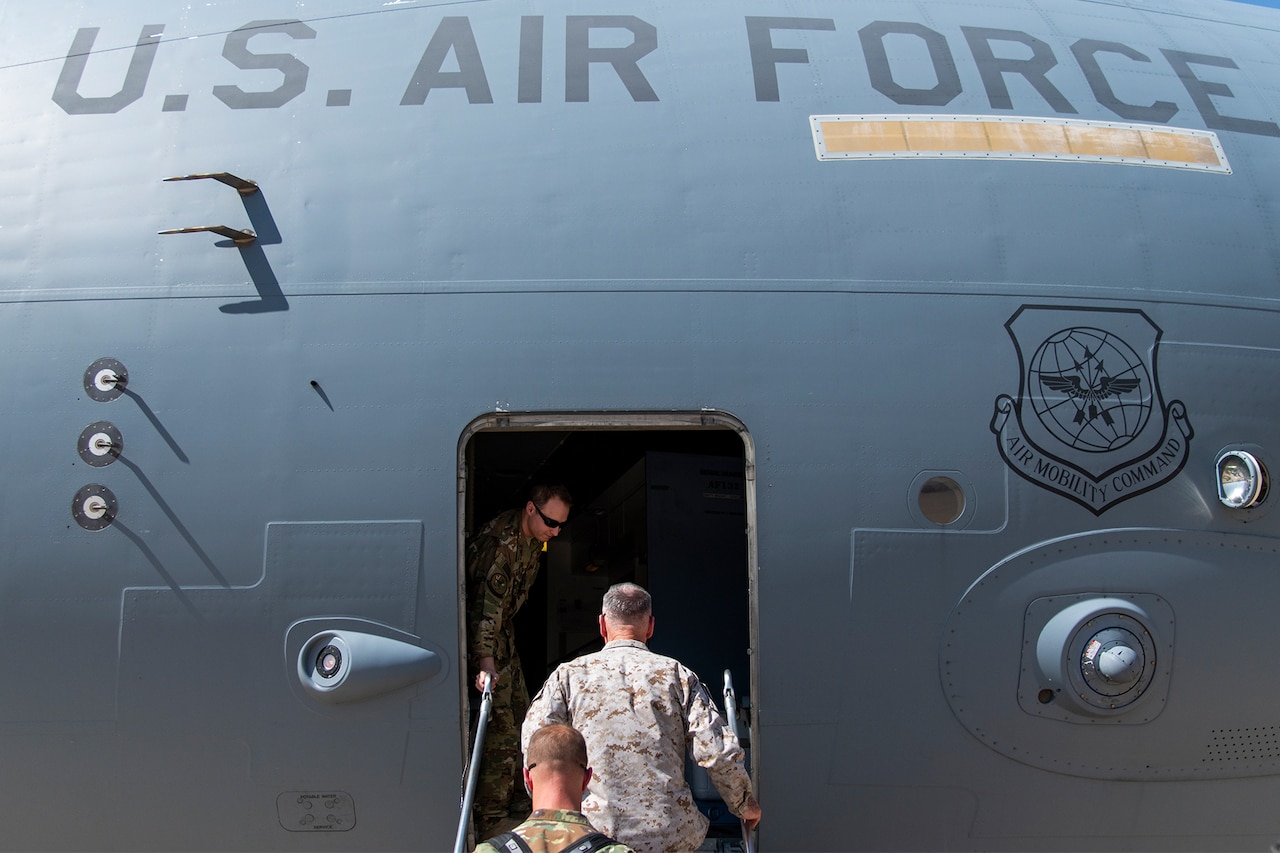 A man walks in a plane.