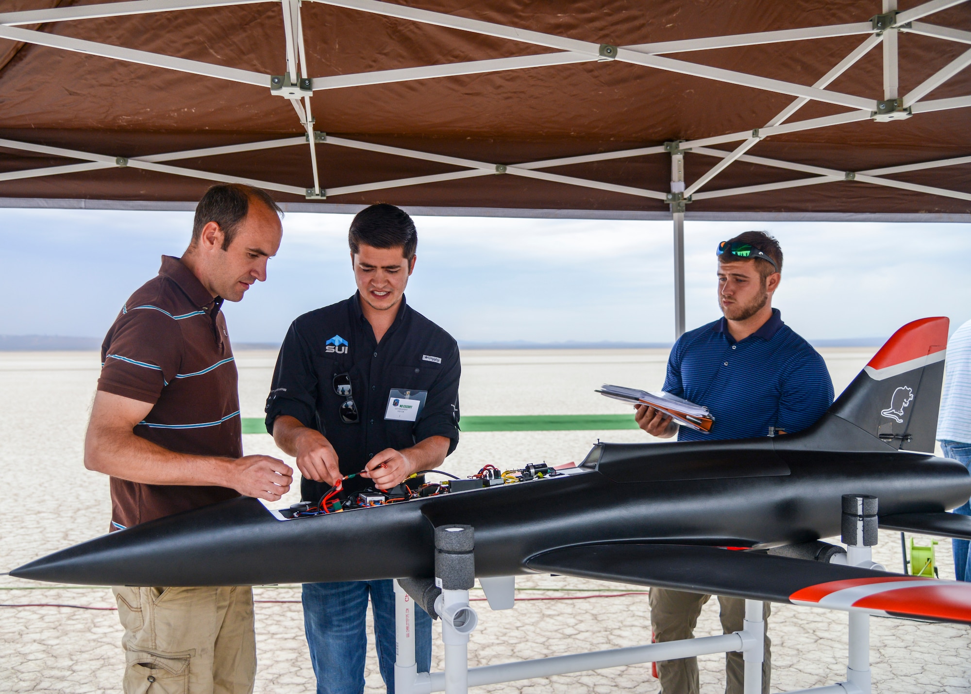 Engineers prepare an unmanned jet-powered aircraft for a flight test at Edwards Air Force Base, Calif., July 25. The flight tested a software suite called TACE, Testing Autonomy in a Complex Environment, developed by John Hopkins Applied Physics Lab. (U.S. Air Force photo by Giancarlo Casem)