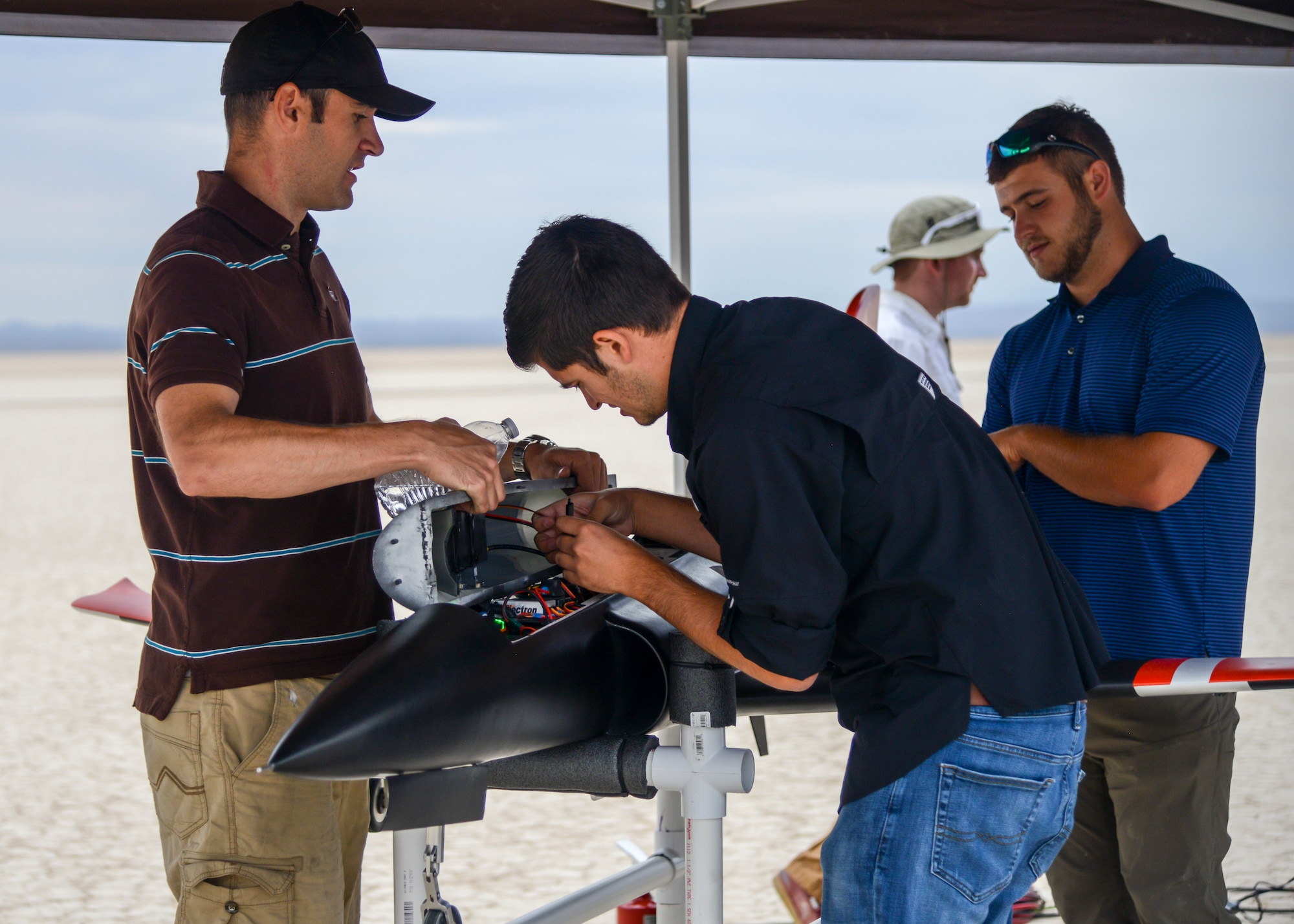 Engineers prepare an unmanned jet-powered aircraft for a flight test at Edwards Air Force Base, Calif., July 25. The flight tested a software suite called TACE, Testing Autonomy in a Complex Environment, developed by John Hopkins Applied Physics Lab. (U.S. Air Force photo by Giancarlo Casem)