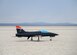 An unmanned jet-powered aircraft takes off from dry lake bed at Edwards Air Force Base, Calif., July 25. The flight tested a software suite called TACE, Testing Autonomy in a Complex Environment, developed by John Hopkins Applied Physics Lab. (U.S. Air Force photo by Giancarlo Casem)
