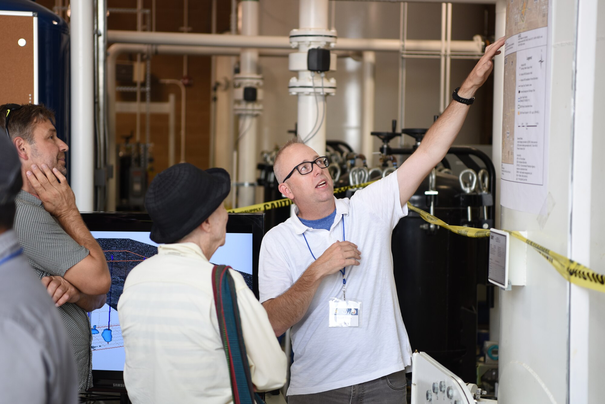 Scott Clark, U.S. Air Force Civil Engineer Center, explains how water is cleaned at the groundwater treatment system facility at Kirtland Air Force Base, N.M., July 25, 2019. Kirtland AFB hosted an open house to give the public the opportunity to learn and ask questions about the work being done to remove groundwater contamination. (U.S. Air Force photo by Senior Airman Eli Chevalier)