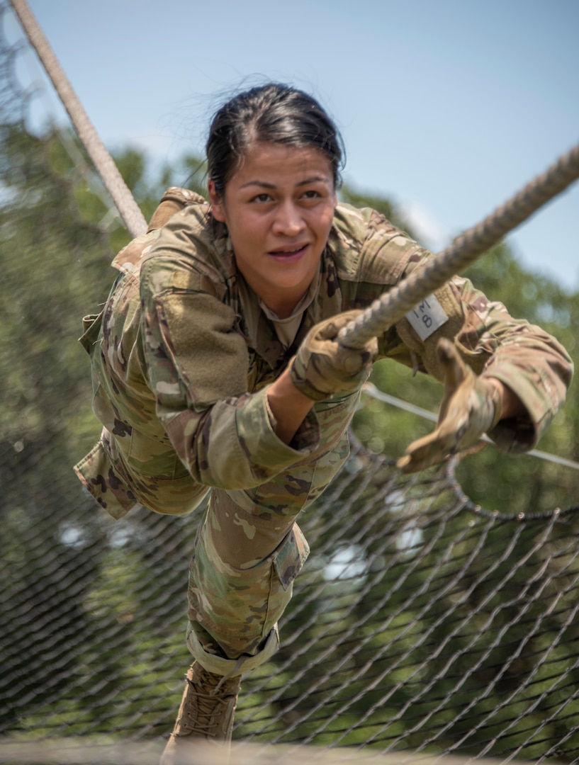 Sgt. Samantha Delgado, a Brooke Army Medical Center diagnostic radiology technician, tackles the obstacle course during the four-day Regional Health Command-Central Best Medic Competition at Joint Base San Antonio-Camp Bullis. Delgado was part of the winning team that will compete in the Army Medicine Best Medic competition this fall.