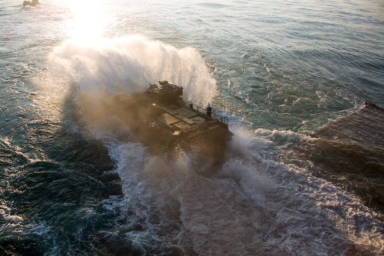 U.S. Marines with Golf Company, Battalion Landing Team, 2nd Battalion, 8th Marine Regiment, 26th Marine Expeditionary Unit (MEU), conduct ship-to-shore movements utilizing amphibious assault vehicles (AAV) from Harpers Ferry-class dock landing ship USS Oak Hill (LSD 51) during Amphibious Squadron (PHIBRON) MEU Integration Training (PMINT) in vicinity of Camp Lejeune, North Carolina, July 15 2019. PMINT is part of the 26th MEU’s and PHIBRON 8’s pre-deployment training program, which enhances interoperability and familiarizes Marines and Sailors to life on ship prior to deployment. (U.S. Marine Corps photo by Cpl. Nathan Reyes)
