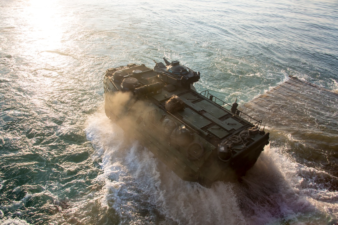 U.S. Marines with Golf Company, Battalion Landing Team, 2nd Battalion, 8th Marine Regiment, 26th Marine Expeditionary Unit (MEU), conduct ship-to-shore movements utilizing amphibious assault vehicles (AAV) from Harpers Ferry-class dock landing ship USS Oak Hill (LSD 51) during Amphibious Squadron (PHIBRON) MEU Integration Training (PMINT) in vicinity of Camp Lejeune, North Carolina, July 15 2019. PMINT is part of the 26th MEU’s and PHIBRON 8’s pre-deployment training program, which enhances interoperability and familiarizes Marines and Sailors to life on ship prior to deployment. (U.S. Marine Corps photo by Cpl. Nathan Reyes)