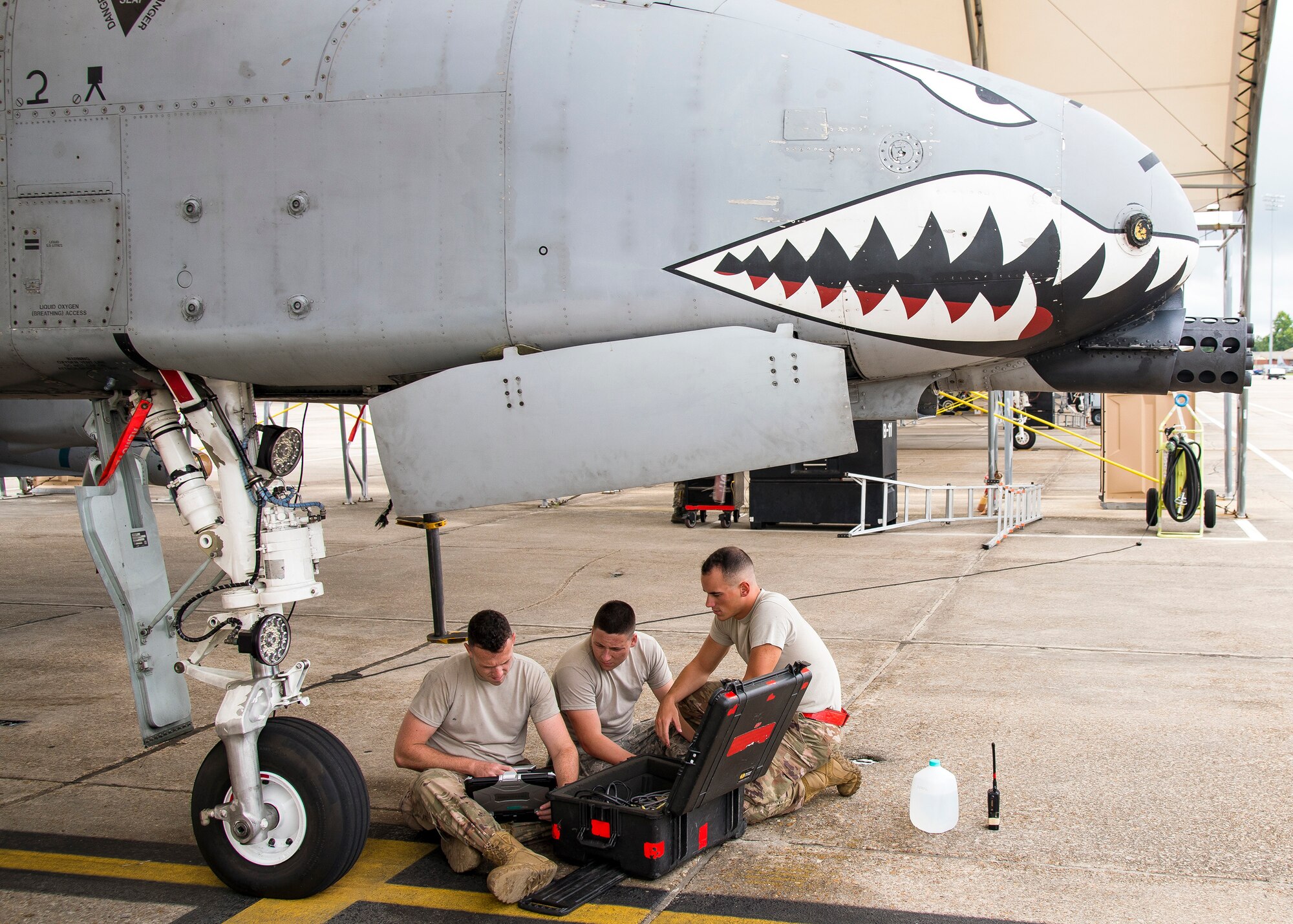 Airmen from the 75th Aircraft Maintenance Unit read a technical order during a sortie surge exercise, July 24, 2019, at Moody Air Force Base, Ga. The exercise was conducted to determine Airmen's abilities to perform effectively while generating combat or training sorties at an accelerated rate. Throughout the four-day surge, pilots and maintainers completed 131 sorties spanning approximately 152 flying hours. (U.S. Air Force photo by Airman 1st Class Eugene Oliver)