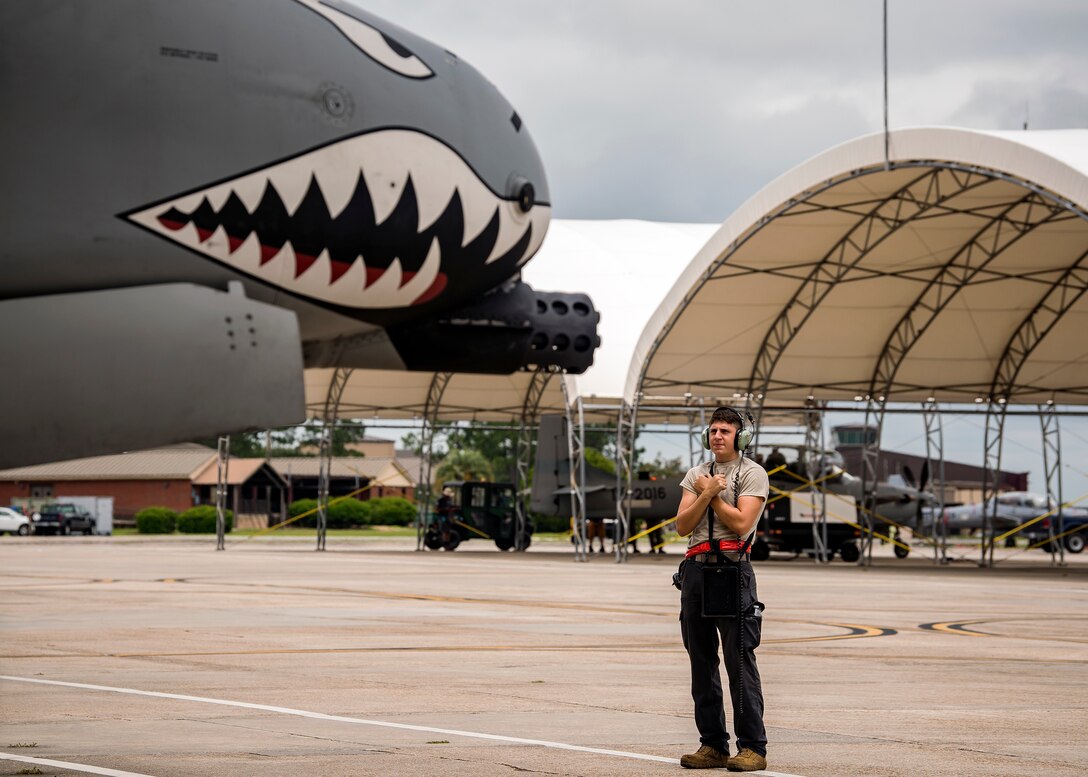 Airman 1st Class Corbin Anderson, 75th Aircraft Maintenance Unit crew chief, marshals an A-10C Thunderbolt II onto the taxiway during a sortie surge exercise, July 24, 2019, at Moody Air Force Base, Ga. The exercise was conducted to determine Airmen's abilities to perform effectively while generating combat or training sorties at an accelerated rate. Throughout the four-day surge, pilots and maintainers completed 131 sorties spanning approximately 152 flying hours. (U.S. Air Force photo by Airman 1st Class Eugene Oliver)