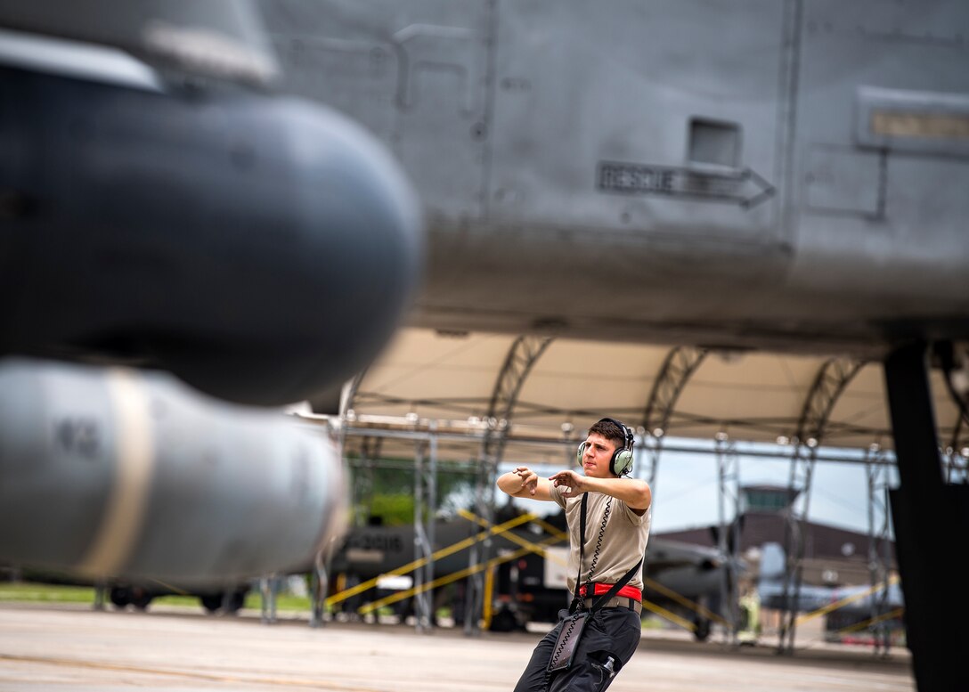 Airman 1st Class Corbin Anderson, 75th Aircraft Maintenance Unit crew chief, marshals an A-10C Thunderbolt II onto the taxiway during a sortie surge exercise, July 24, 2019, at Moody Air Force Base, Ga. The exercise was conducted to determine Airmen's abilities to perform effectively while generating combat or training sorties at an accelerated rate. Throughout the four-day surge, pilots and maintainers completed 131 sorties spanning approximately 152 flying hours. (U.S. Air Force photo by Airman 1st Class Eugene Oliver)