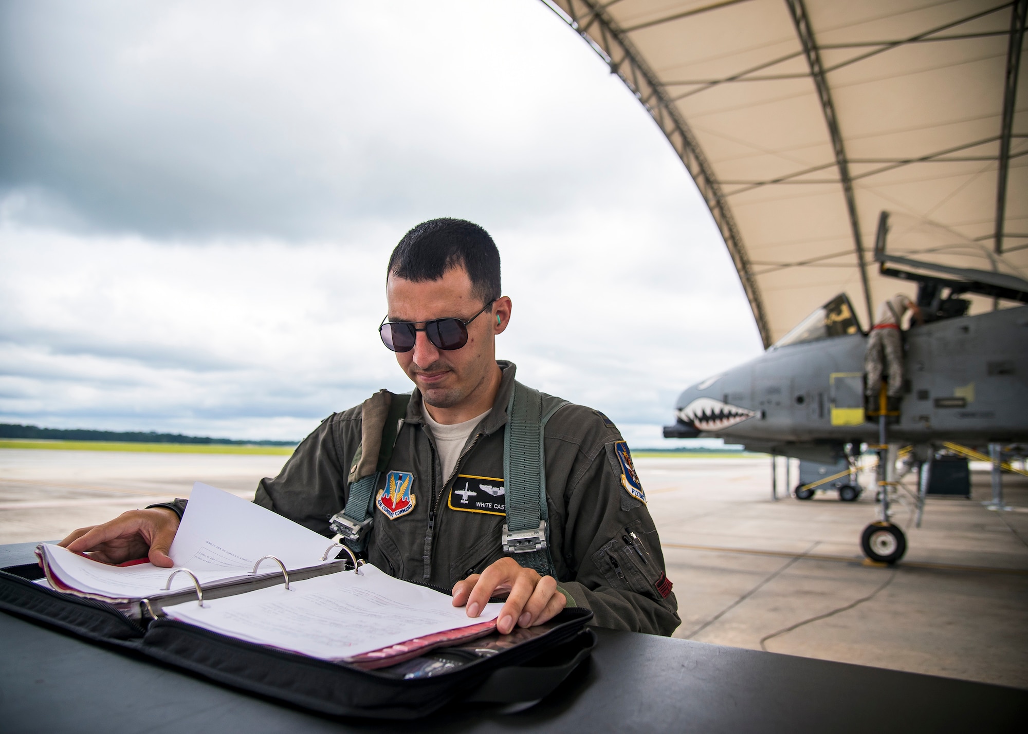 Capt. Nicklas Castle, 75th Fighter Squadron A-10C Thunderbolt II pilot, reads a flight plan during a sortie surge exercise, July 24, 2019, at Moody Air Force Base, Ga. The exercise was conducted to determine Airmen's abilities to perform effectively while generating combat or training sorties at an accelerated rate. Throughout the four-day surge, pilots and maintainers completed 131 sorties spanning approximately 152 flying hours. (U.S. Air Force photo by Airman 1st Class Eugene Oliver)