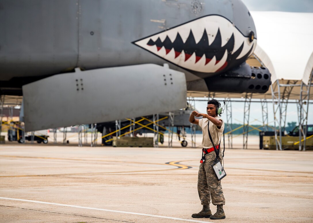 Airman 1st Class Kezrion Mims, 75th Aircraft Maintenance Unit crew chief, marshals an A-10C Thunderbolt II onto the taxiway during a sortie surge exercise, July 24, 2019, at Moody Air Force Base, Ga. The exercise was conducted to determine Airmen's abilities to perform effectively while generating combat or training sorties at an accelerated rate. Throughout the four-day surge, pilots and maintainers completed 131 sorties spanning approximately 152 flying hours. (U.S. Air Force photo by Airman 1st Class Eugene Oliver)