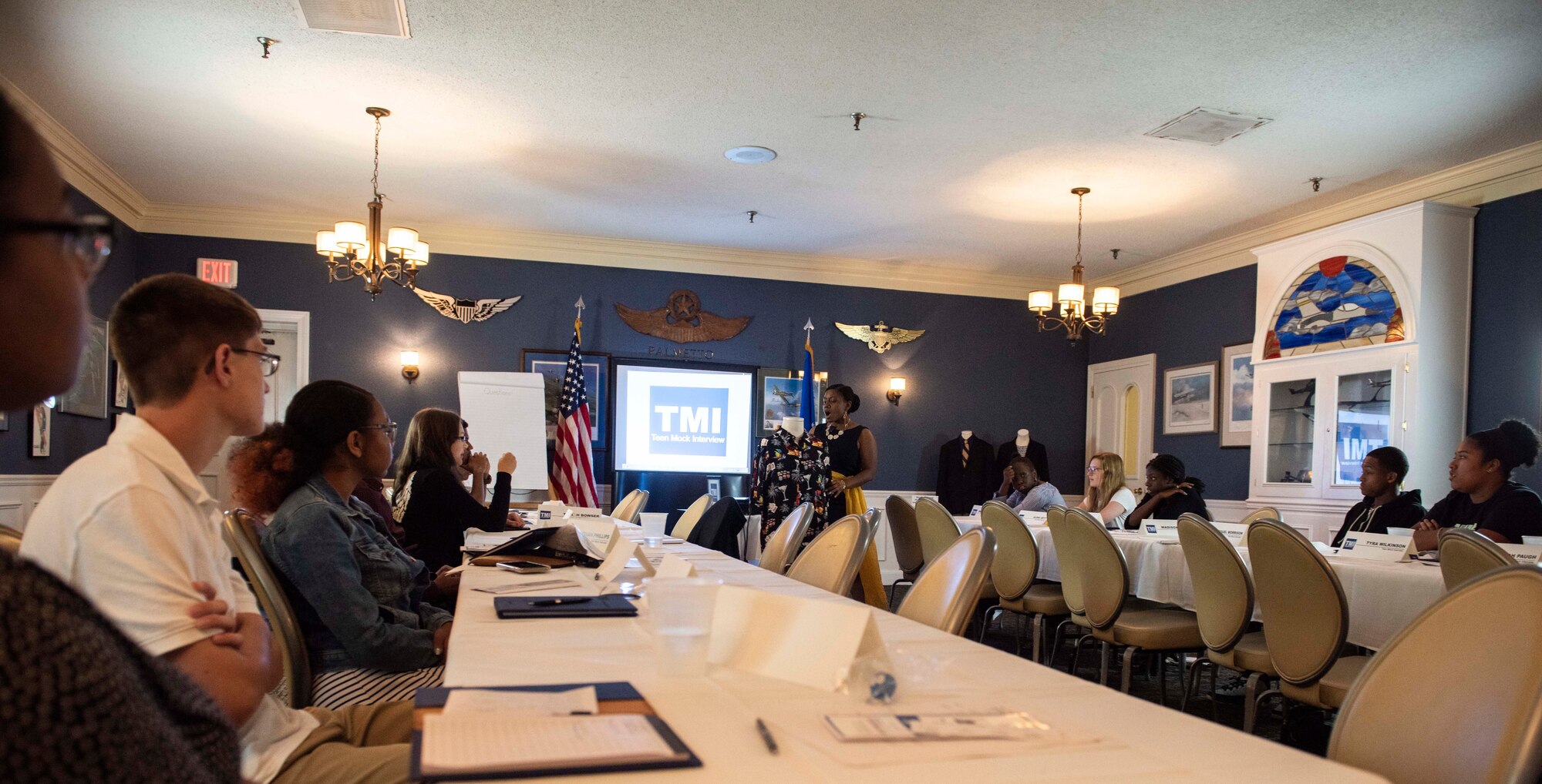 Erica Williams, Sumter Economic Development Board member, shows middle and high school students how not to dress for a professional interview at Shaw Air Force Base, South Carolina, July 24, 2019.