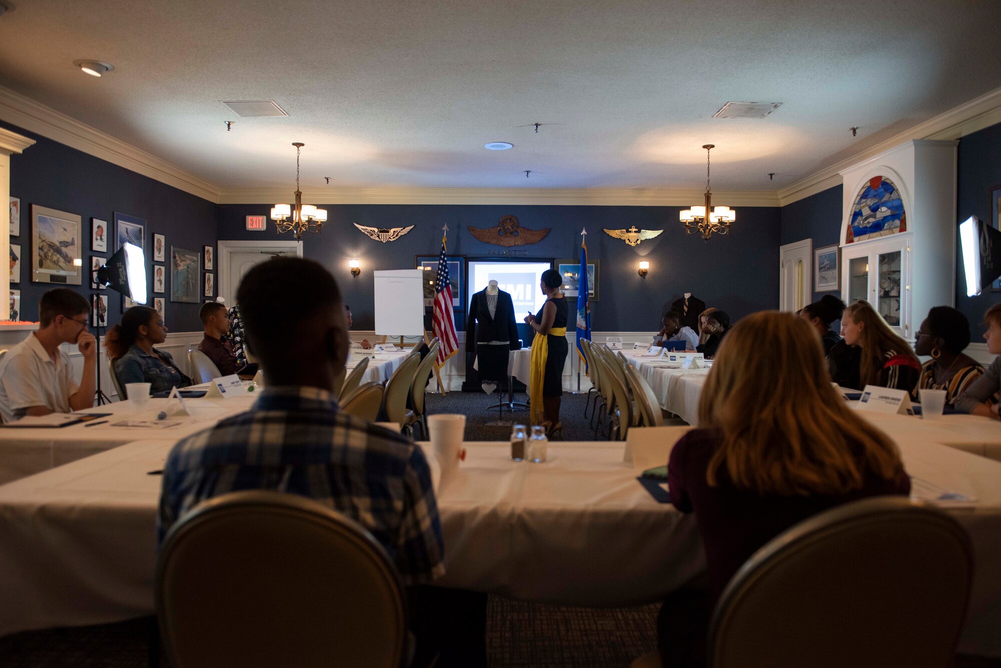 Erica Williams, Sumter Economic Development Board member, shows middle and high school students how not to dress for a professional interview at Shaw Air Force Base, South Carolina, July 24, 2019.