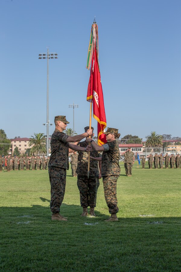 U.S. Marine Corps Col. Brian Rideout, on-coming commanding officer, I Marine Expeditionary Force Information Group, receives the unit colors from Col. Dawn Alonso, off-going commanding officer, I Marine Expeditionary Force Information Group during a change of command ceremony at Marine Corps Base Camp Pendleton, California, July 26, 2019. Col. Dawn Alonso relinquished command to Col. Brian Rideout as commanding officer of I Marine Expeditionary Force Information Group. (U.S. Marine Corps photo by Cpl. Anabel Abreu Rodriguez)