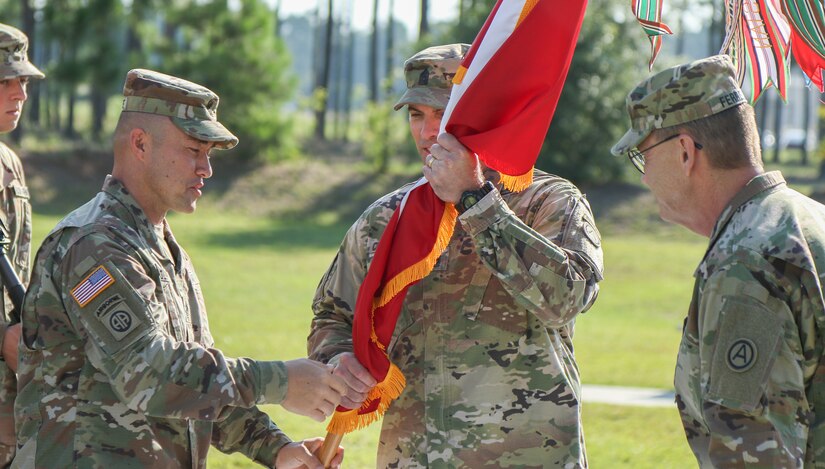 Sgt. Maj. John Condliffe, operations sergeant major (left), passes the U.S. Army Central colors to Sgt. Maj. Curt Cornelison (center), during Cornelison’s relinquishment of responsibility ceremony at USARCENT’s headquarters, Shaw Air Force Base, S.C., Jul. 29, 2019. Cornelison was recently selected to serve as the U.S. Army Forces Command senior enlisted advisor, a 4-star command located at Fort Bragg, N.C., and largest U.S. Army command with more than 750,000 Active Army, U.S. Army Reserve and U.S. Army National Guard Soldiers.