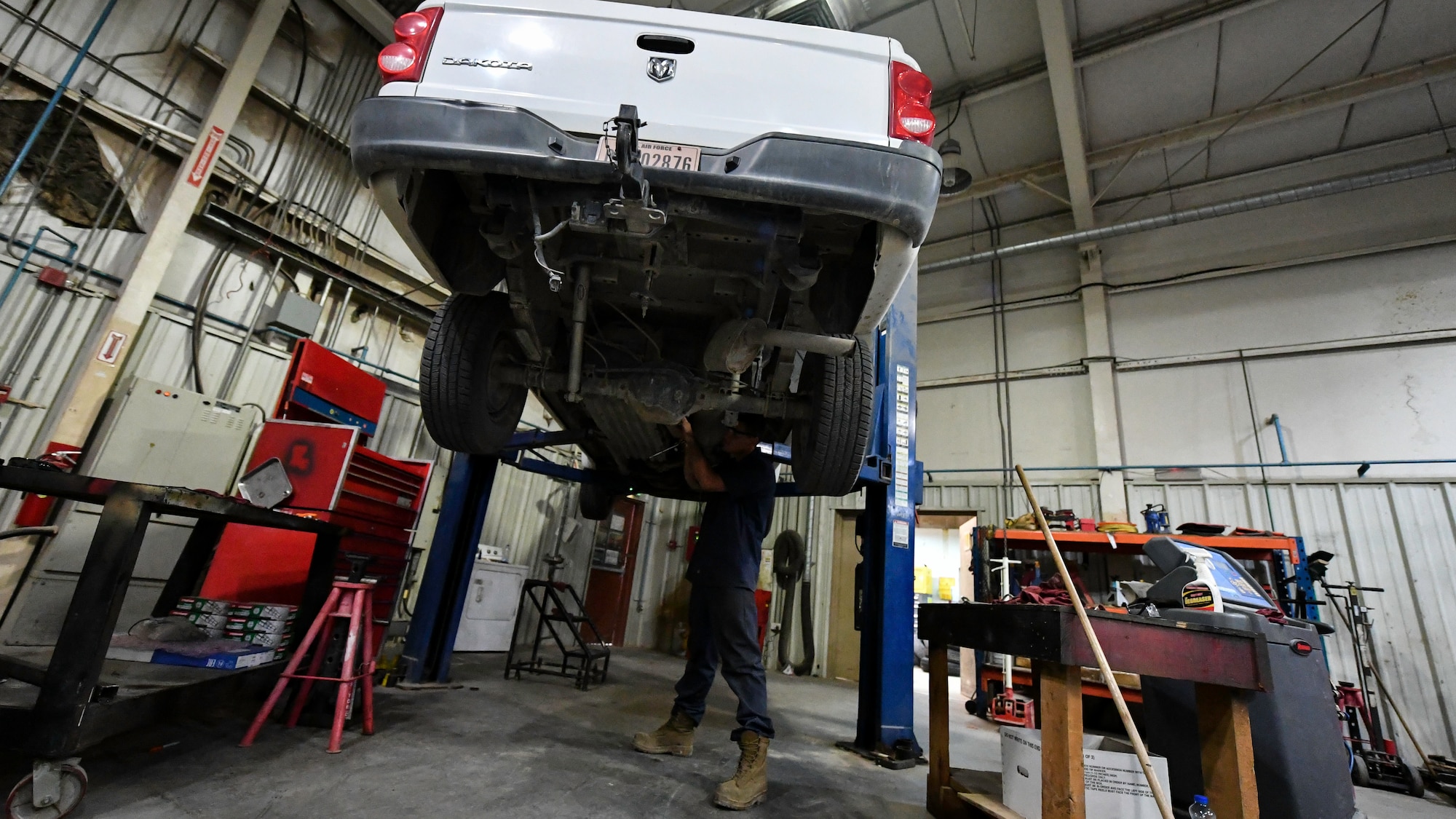 U.S. Air Force Senior Airman Darian O’Banion, 386th Expeditionary Logistics Readiness Squadron vehicle and equipment maintenance journeyman, secures a driveshaft to a vehicle at Ali Al Salem Air Base, Kuwait, July 29, 2019. Airmen assigned to the vehicle and equipment maintenance shop work on an average of 10 different automobiles a week. (U.S. Air Force photo by Staff Sgt. Mozer O. Da Cunha)