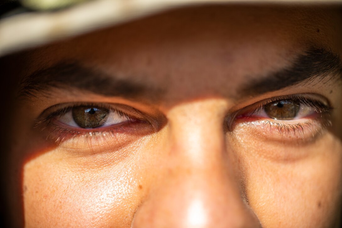 A U.S. Navy Corpsman attached to Scout Sniper Platoon, 1st Battalion, 25th Marine Regiment, 4th Marine Division, oversees scout sniper Marines at Marine Corps Air Ground Combat Center Twentynine Palms, Calif.