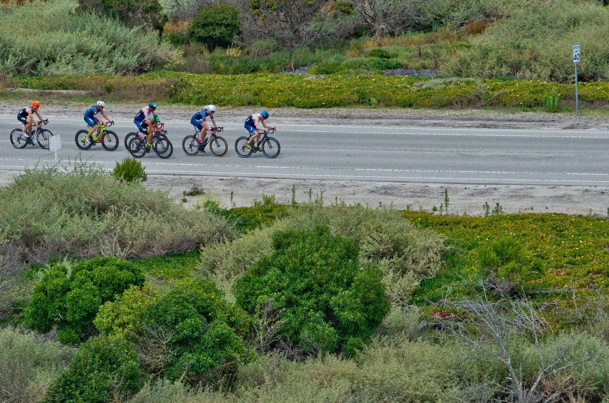 POINT MUGU, Calif. (June 22, 2019) Competitors, including Capt. John Bierman, 21st Space Warning Squadron crew commander (far right)  participate in the bicycle portion of the Armed Forces Triathlon held at Naval Base Ventura County in Point Mugu, California. The triathlon included a 1.5-kilometer swim, 40-kilometer bike ride and a 10-kilometer run. (U.S. Navy photo by Mass Communication Specialist 2nd Class Jesse L. Gonzalez).