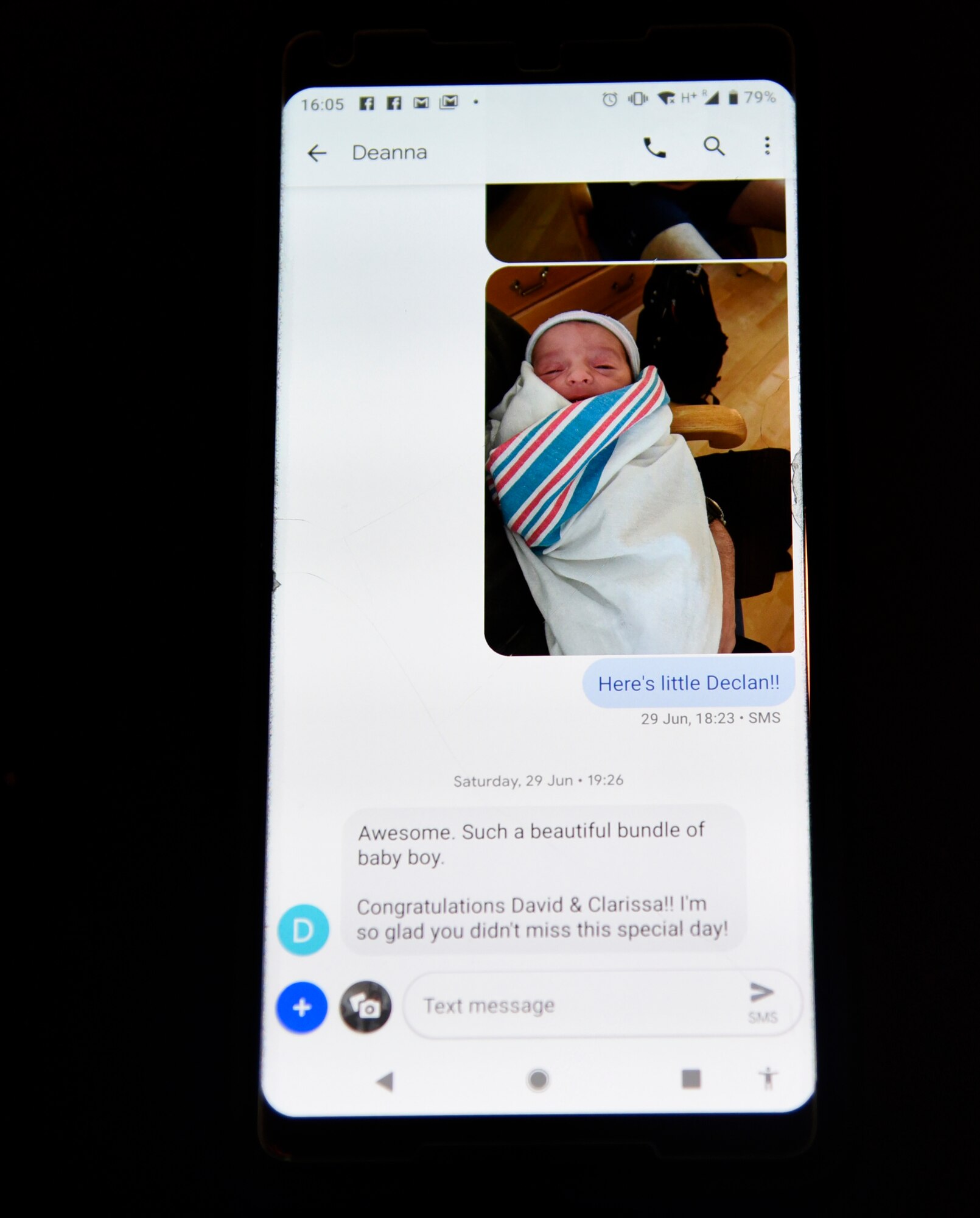 Staff Sgt. David Cuff, 821st Security Forces Squadron bravo team lead, sends a picture message to Deanna Vogt after the birth of his son, Declan, in Mississippi, June 29, 2019.  Vogt and Cuff travelled together from Baltimore, Maryland, to Jackson, Mississippi, after several flight delays and shared a rental car to get the rest of the way home. (U.S. Air Force photo by Staff Sgt. Alexandra M. Longfellow)
