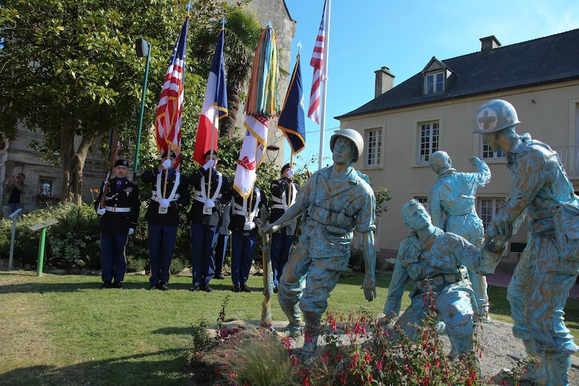 Color Guard Soldiers assigned to the 7th Mission Support Command stand in front of the Four Braves Memorial in Periers, France during the 75th Anniversary of the liberation of the town on July 27, 2019. The 90th Infantry Division, now the 90th Sustainment Brigade, liberated the town during World War II seven weeks after landing on Utah beach just 35 kilometers away. (U.S. Army Reserve Photo by Capt. Joe Bush)