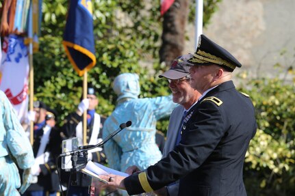 Brig. Gen. Michael T. Harvey, commanding general of the 7th Mission Support Command, embraces Christian Lavaufre, Chairman of the Normandy 44-90th Infantry Division Association, while giving a speech during the 75th Anniversary ceremony of the liberation of Periers, France on July 27, 2019. The 90th Infantry Division, now the 90th Sustainment Brigade, liberated the town during World War II seven weeks after landing on Utah beach just 35 kilometers away. (U.S. Army Reserve Photo by Capt. Joe Bush)